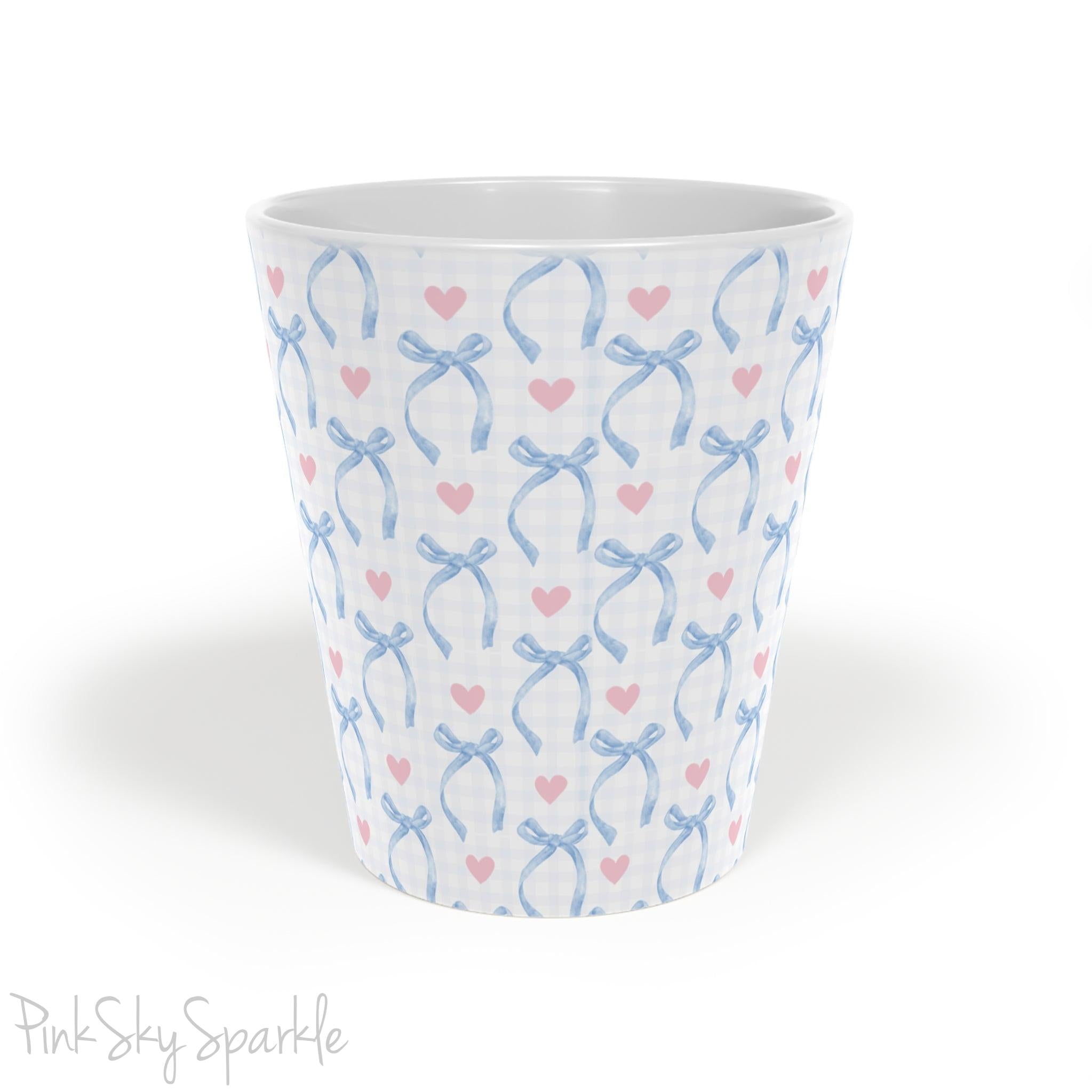 Blue Coquette 12oz Latte Mug,  featuring a light blue gingham print with delicate blue bows and pink hearts, this cute and stylish mug is perfect for your favourite coffee, tea, or hot cocoa.