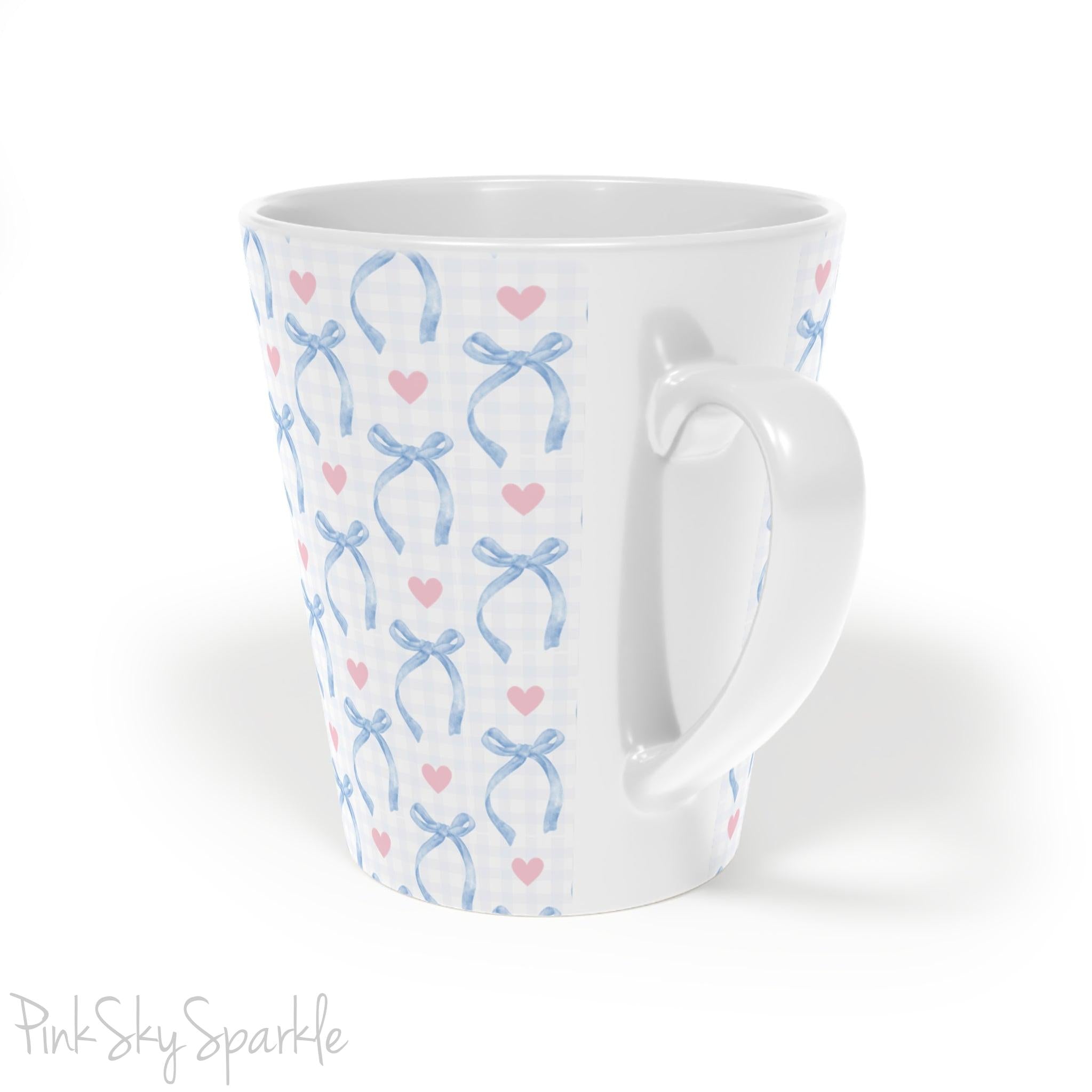 Blue Coquette 12oz Latte Mug,  featuring a light blue gingham print with delicate blue bows and pink hearts, this cute and stylish mug is perfect for your favourite coffee, tea, or hot cocoa.