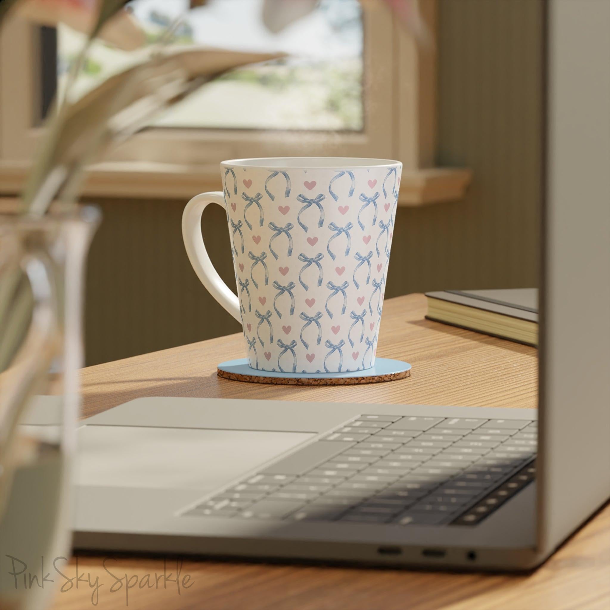 Blue Coquette 12oz Latte Mug,  featuring a light blue gingham print with delicate blue bows and pink hearts, this cute and stylish mug is perfect for your favourite coffee, tea, or hot cocoa.