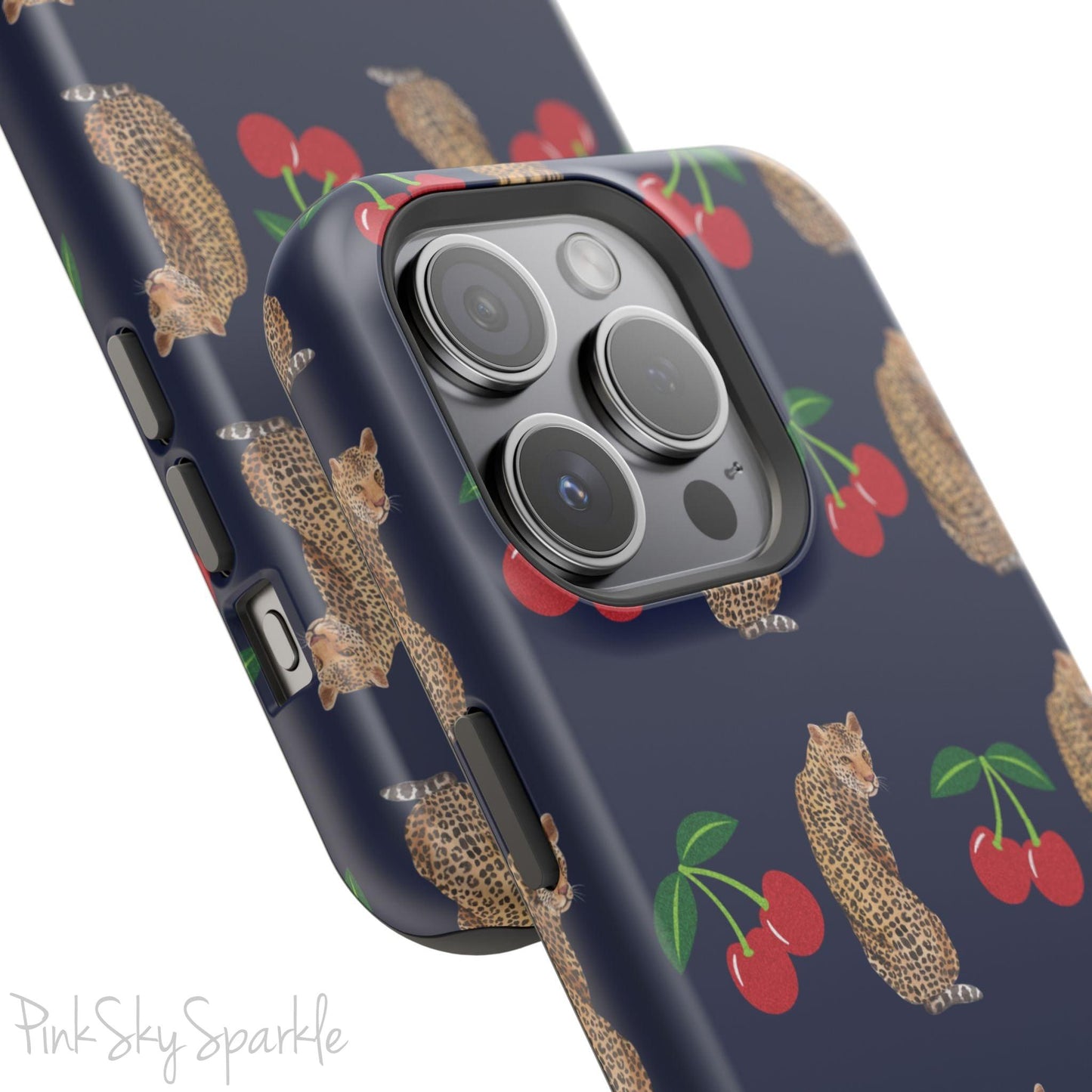 A stylish magnetic iPhone case featuring a unique pattern of leopards and bright red cherries on a dark navy blue background, blending bold and playful elements.
