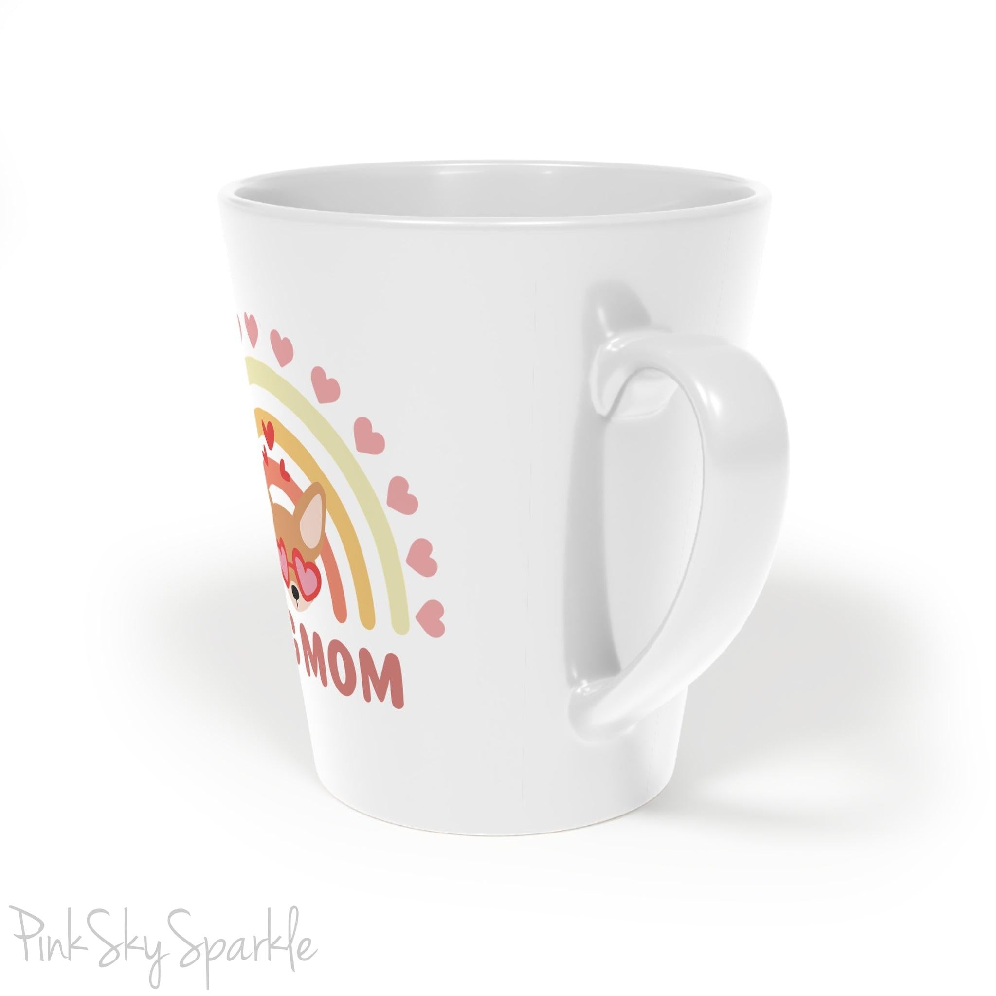 Dog Mom, Rainbow & Hearts Latte Mug. A white 12oz latte mug featuring a boho style rainbow with hearts and a chihuahua wearing heart shaped glasses in the center and the words Dog Mom written in all caps below it.