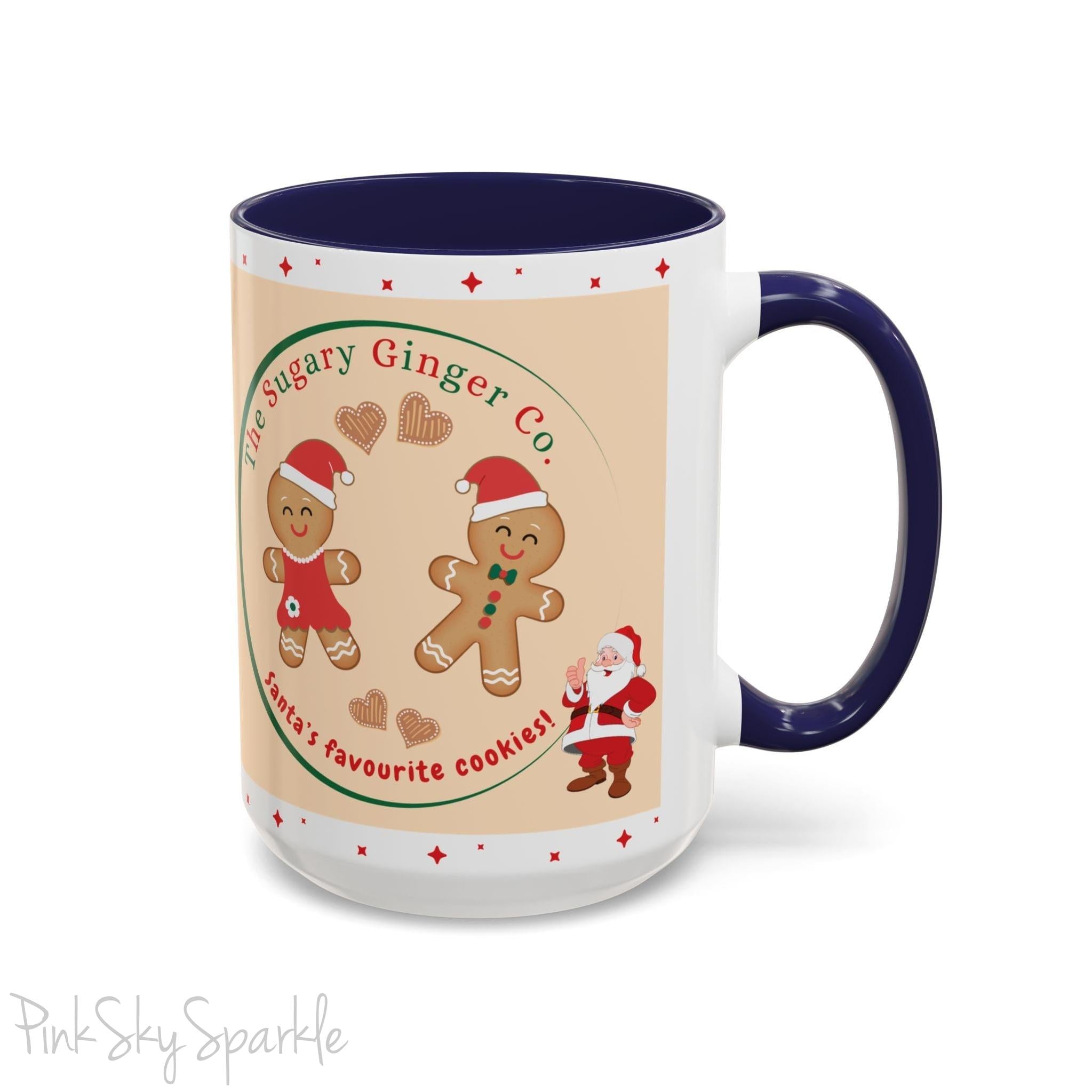 Holiday Gingerbread Coffee Mug featuring a male and female gingerbread cookies next to Santa with giving a thumbs up and the writing The Sugary Ginger Co. written at the top and Santa's favourite cookies at the bottom. The mug has a navy blue handle and navy blue interior.