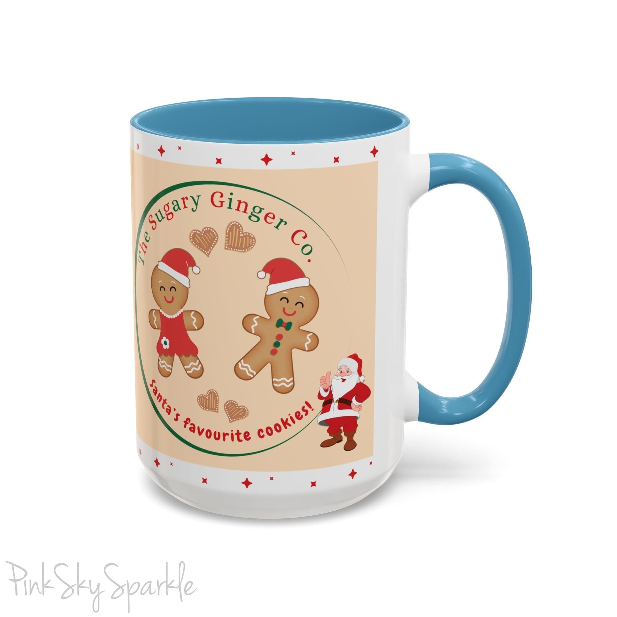 Holiday Gingerbread Coffee Mug featuring a male and female gingerbread cookies next to Santa with giving a thumbs up and the writing The Sugary Ginger Co. written at the top and Santa's favourite cookies at the bottom. The mug has a light blue handle and light blue interior.