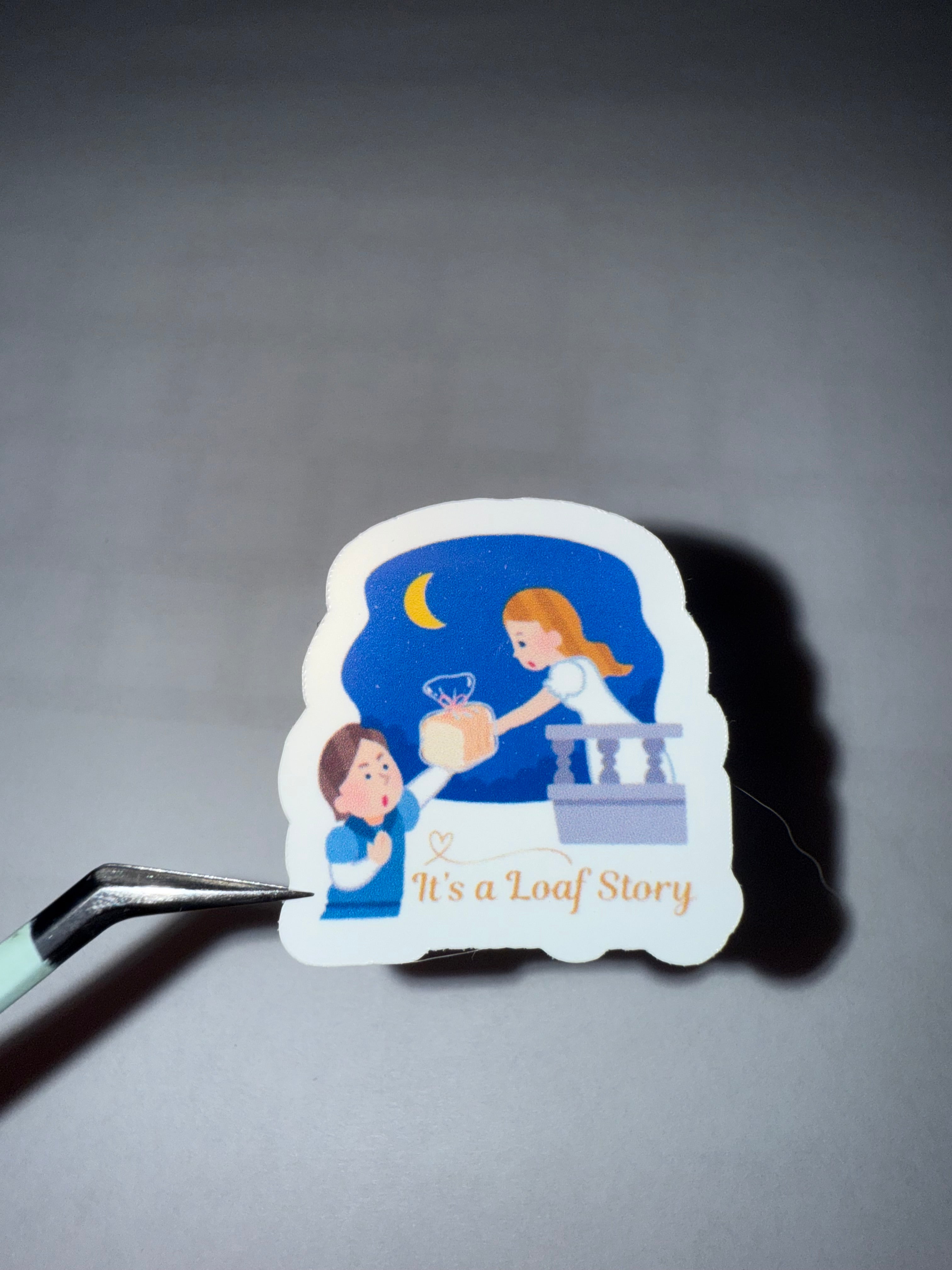 Sticker featuring Romeo and Juliet design where Romeo is handing Juliet a loaf of bread with the pun "It's a Loaf Story".