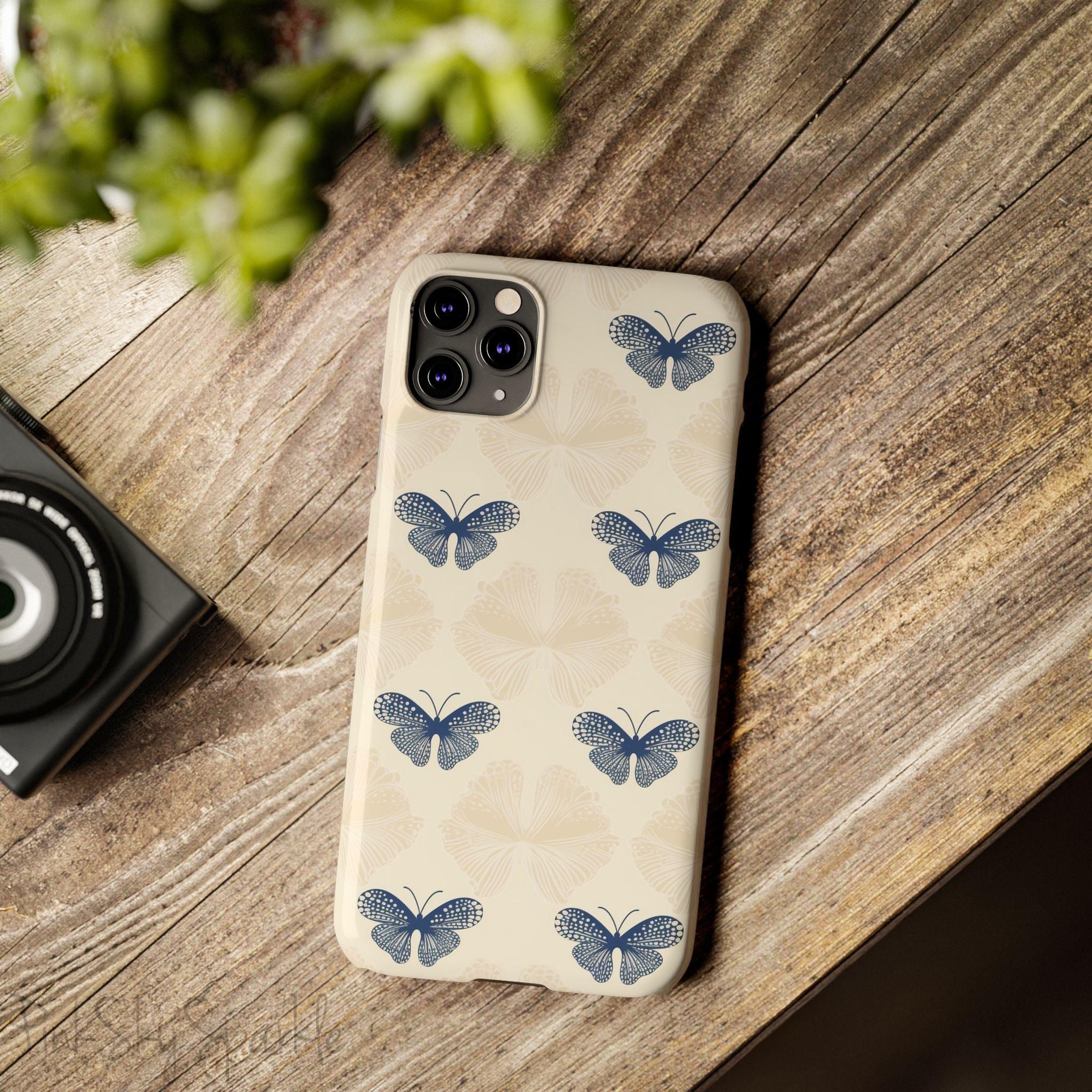 Add a touch of elegance to your phone with the Midnight Flutter Slim iPhone Case. Featuring a neutral background and navy blue butterflies.