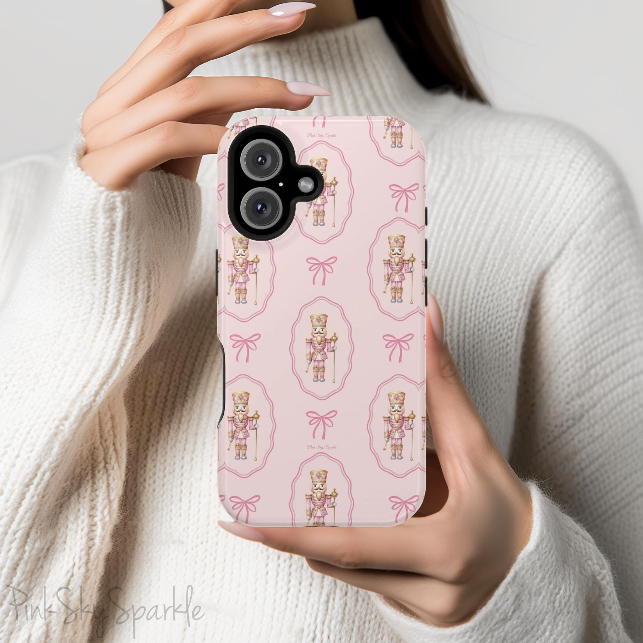 Add a touch of elegance and festive charm to your phone with the Nutcracker Coquette Magnetic iPhone Case. Featuring a chic design with nutcracker motifs, delicate bows, and dainty details, this case is perfect for spreading holiday cheer while keeping your phone protected. Compatible with iPhone models 13, 14, 15, and 16.