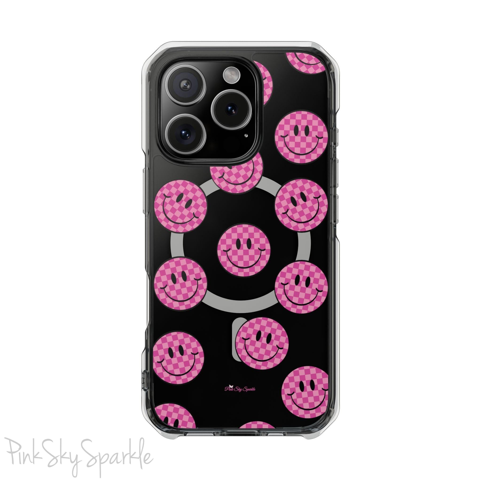 Clear magnetic phone case featuring pink checkered smiley faces on a transparent background, designed for MagSafe® compatibility with air-cushioned bumper corners.