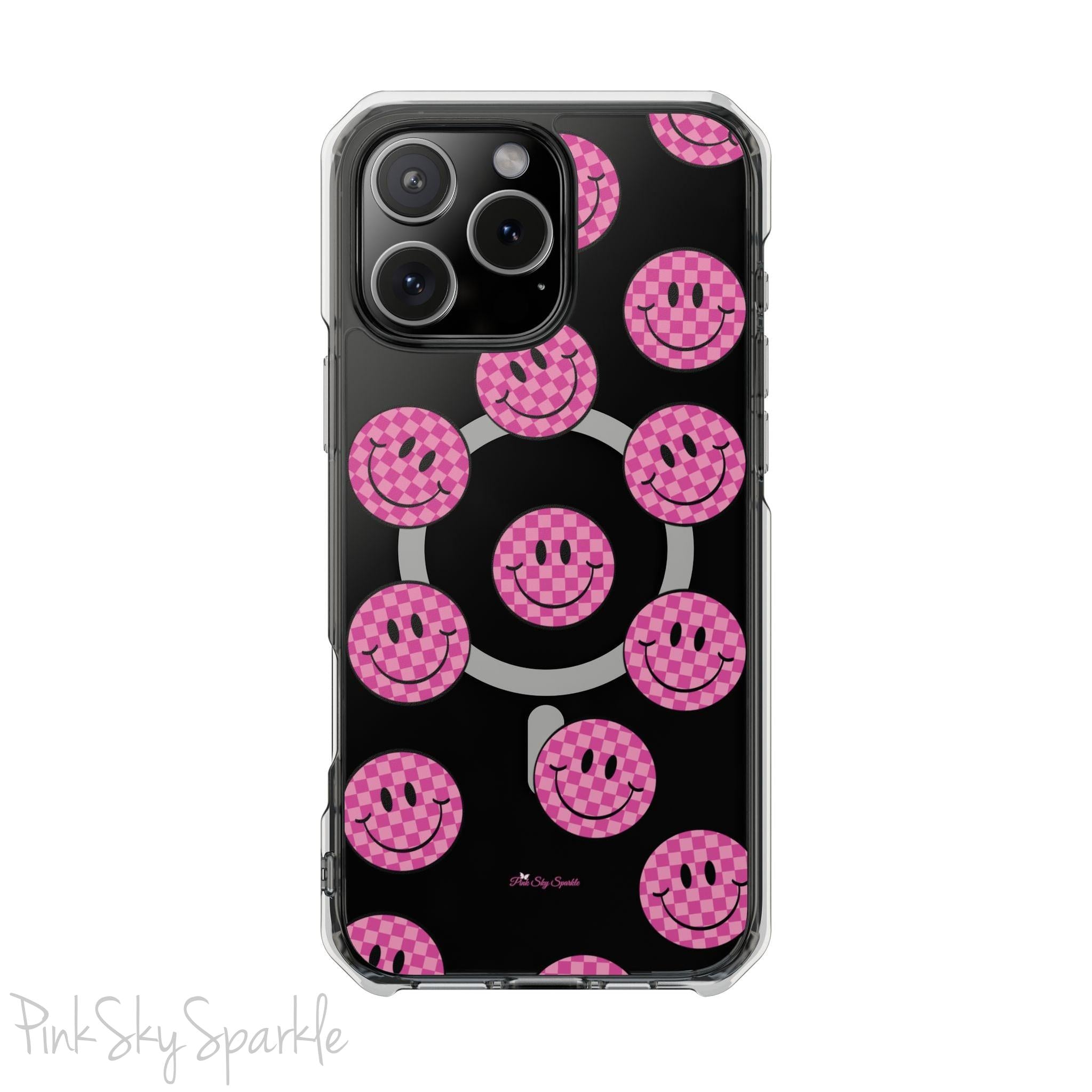 Clear magnetic phone case featuring pink checkered smiley faces on a transparent background, designed for MagSafe® compatibility with air-cushioned bumper corners.
