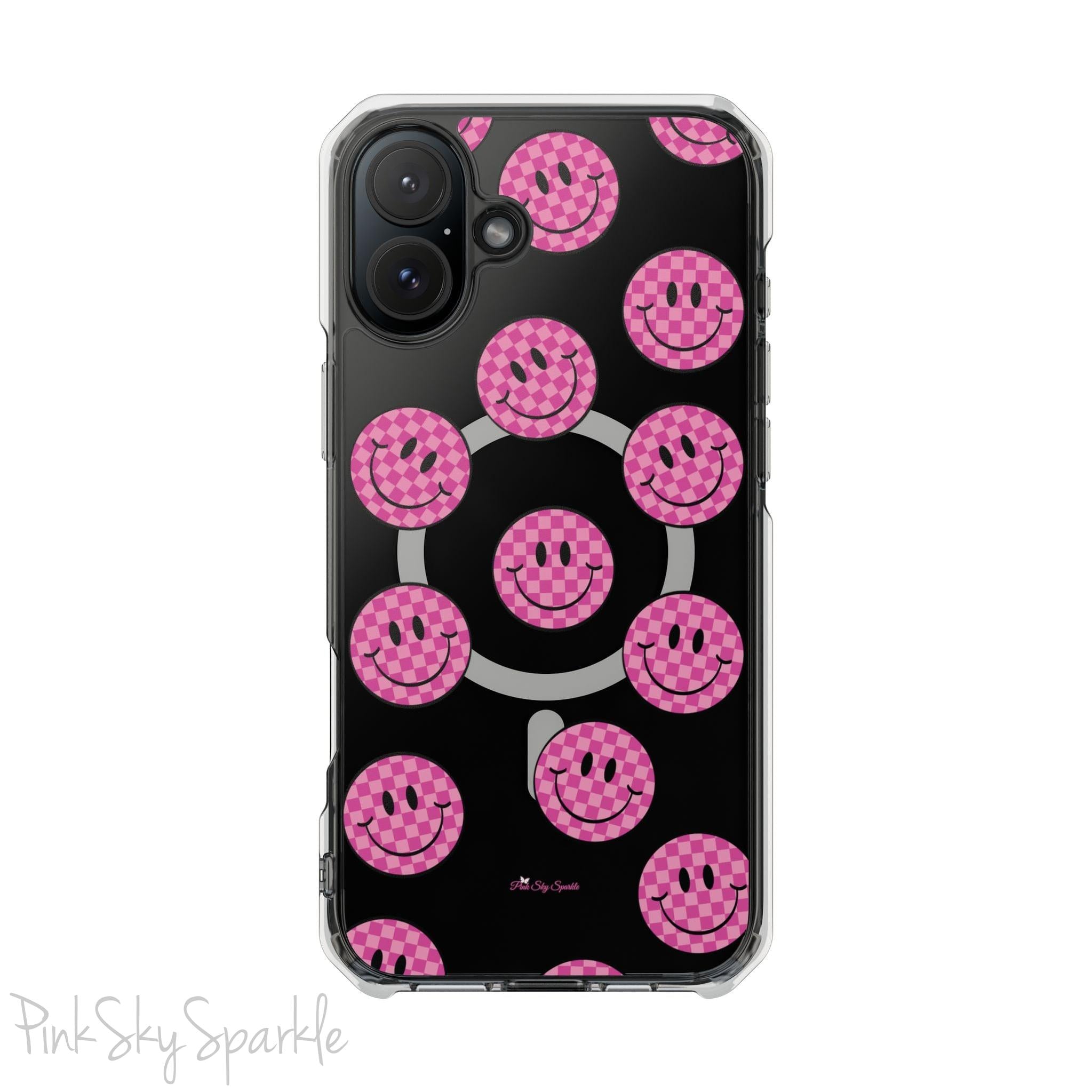 Clear magnetic phone case featuring pink checkered smiley faces on a transparent background, designed for MagSafe® compatibility with air-cushioned bumper corners.