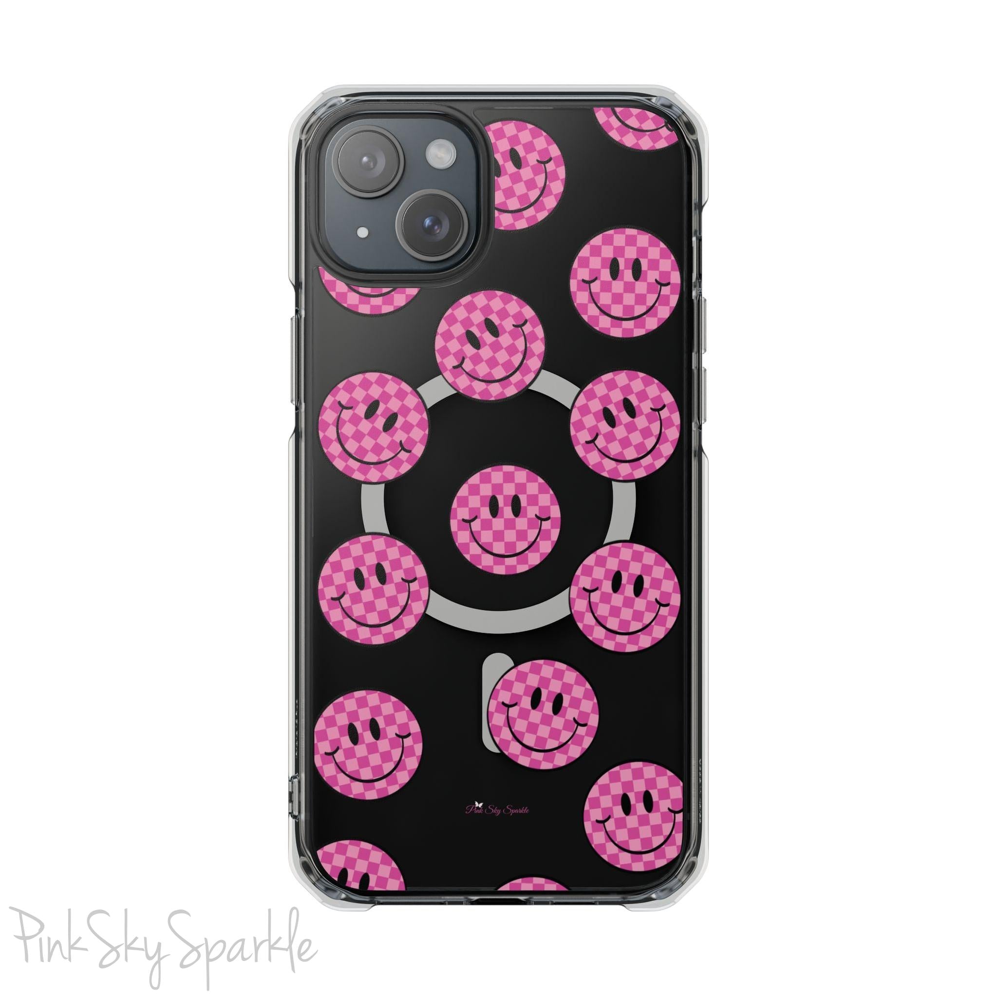Clear magnetic phone case featuring pink checkered smiley faces on a transparent background, designed for MagSafe® compatibility with air-cushioned bumper corners.