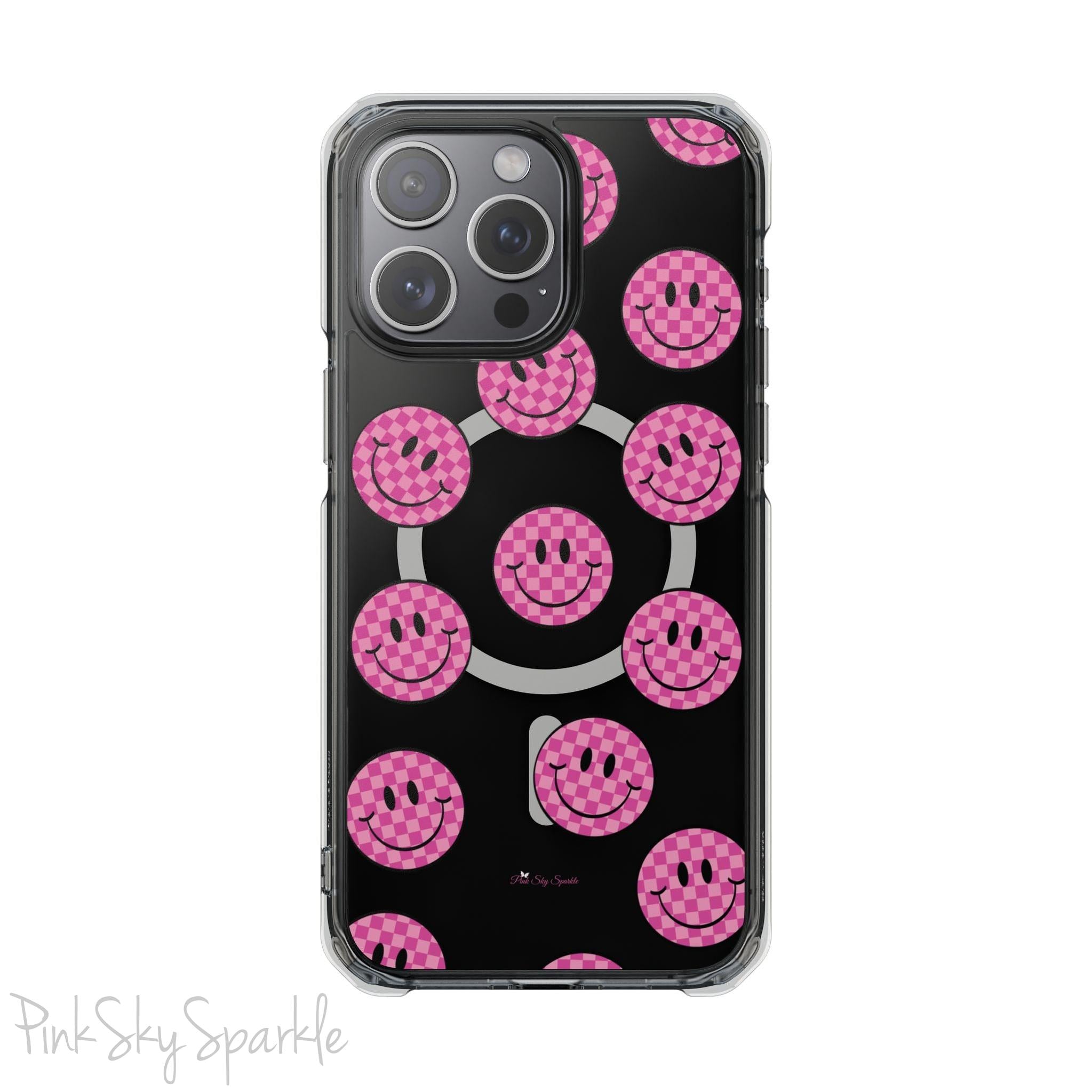 Clear magnetic phone case featuring pink checkered smiley faces on a transparent background, designed for MagSafe® compatibility with air-cushioned bumper corners.