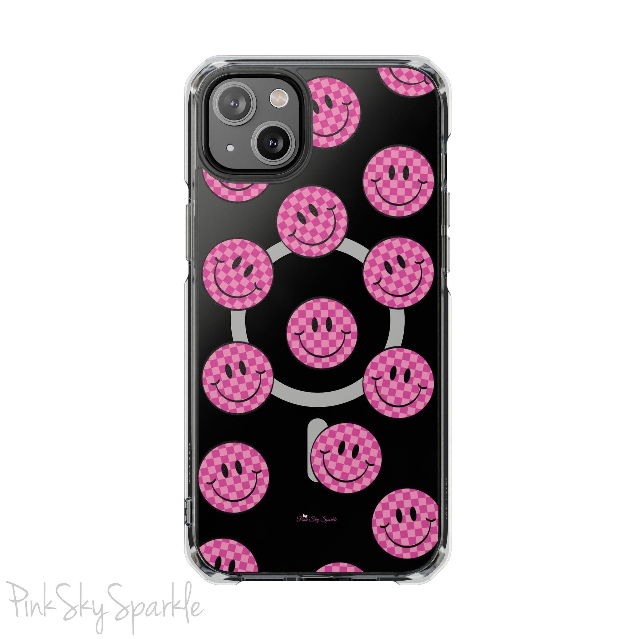 Clear magnetic phone case featuring pink checkered smiley faces on a transparent background, designed for MagSafe® compatibility with air-cushioned bumper corners.