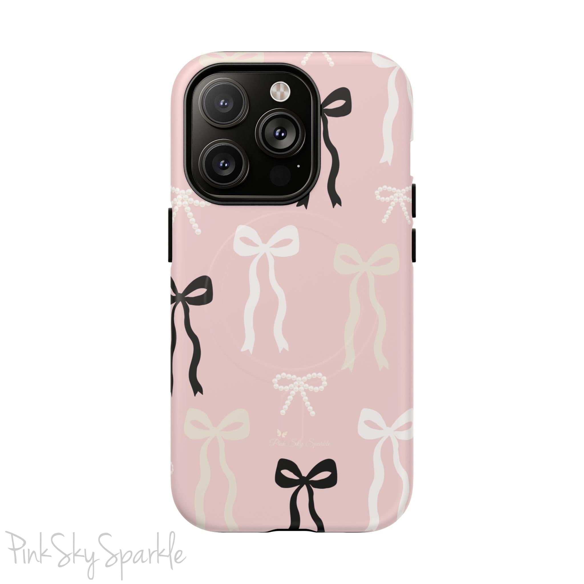 Pink magnetic iPhone case featuring an elegant bow pattern with black, white, and cream bows, designed for MagSafe® compatibility and premium protection.