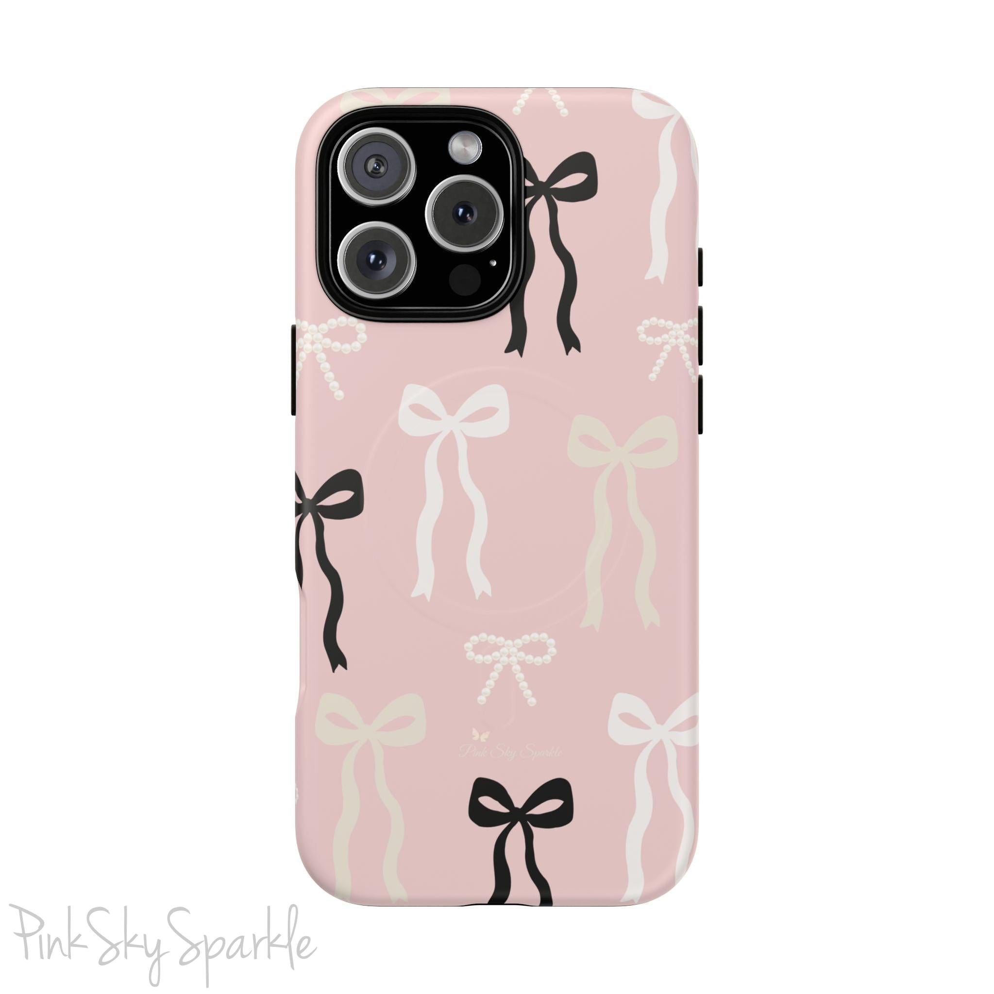 Pink magnetic iPhone case featuring an elegant bow pattern with black, white, and cream bows, designed for MagSafe® compatibility and premium protection.