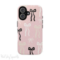 Pink magnetic iPhone case featuring an elegant bow pattern with black, white, and cream bows, designed for MagSafe® compatibility and premium protection.