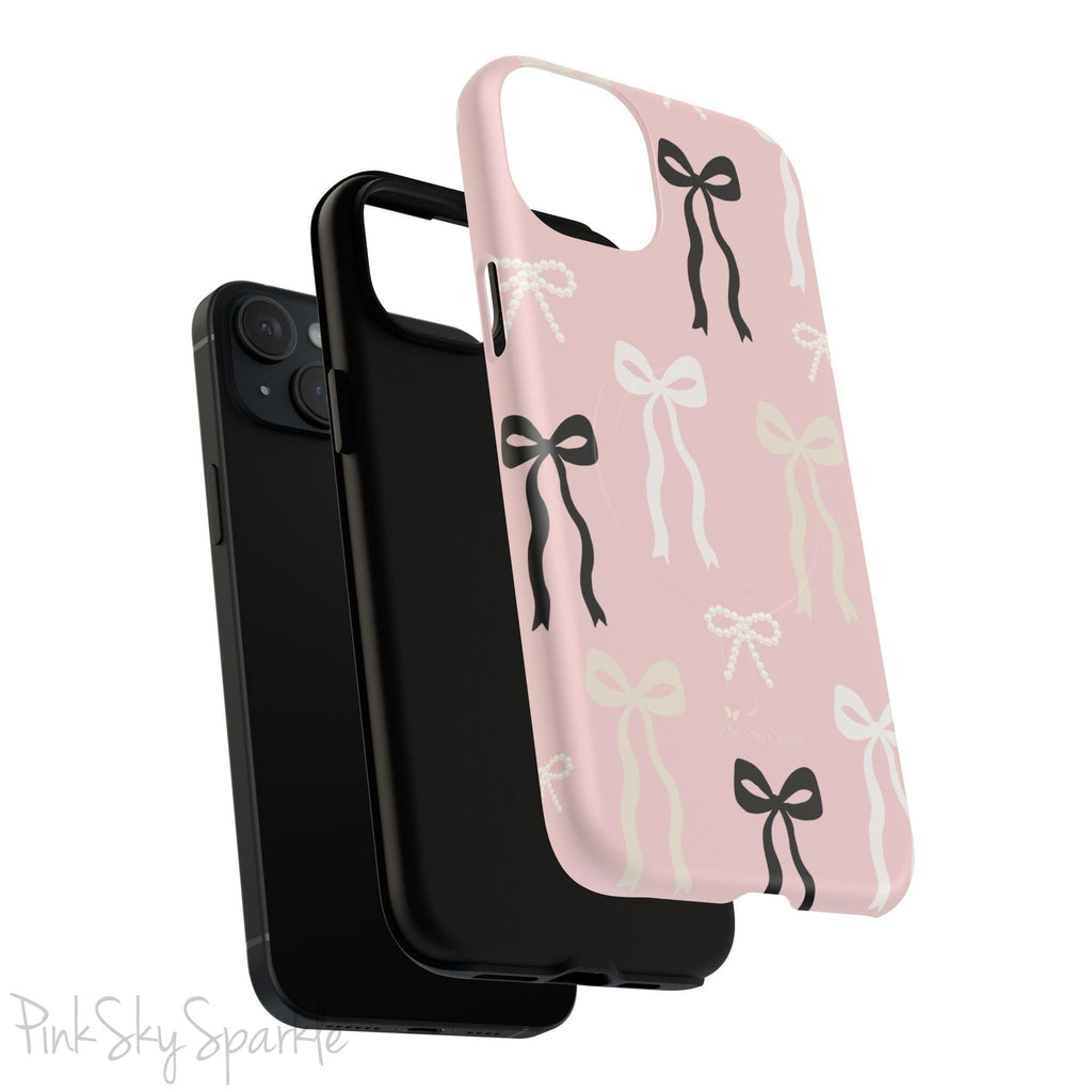 Pink magnetic iPhone case featuring an elegant bow pattern with black, white, and cream bows, designed for MagSafe® compatibility and premium protection.