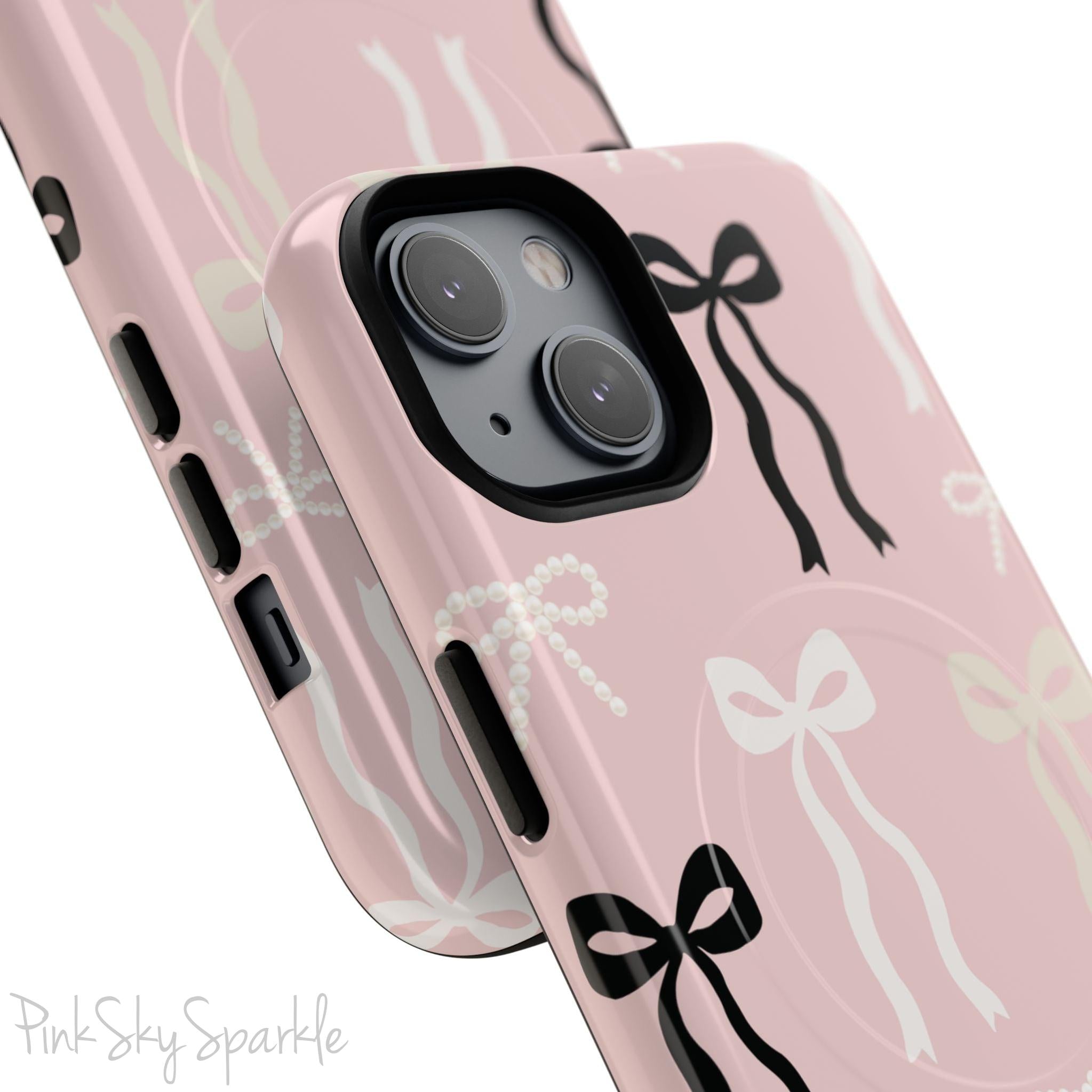 Pink magnetic iPhone case featuring an elegant bow pattern with black, white, and cream bows, designed for MagSafe® compatibility and premium protection.
