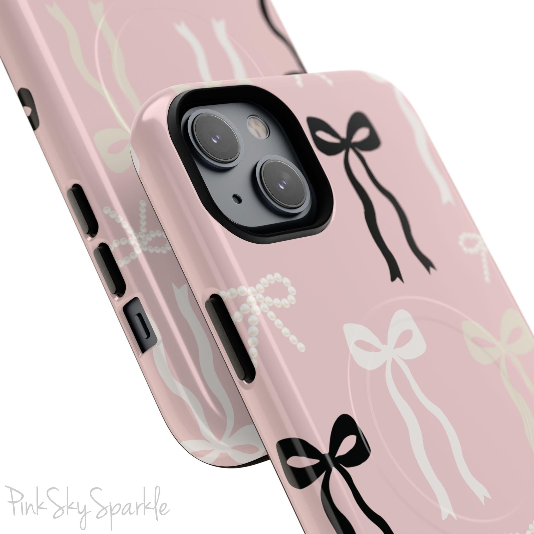 Pink magnetic iPhone case featuring an elegant bow pattern with black, white, and cream bows, designed for MagSafe® compatibility and premium protection.