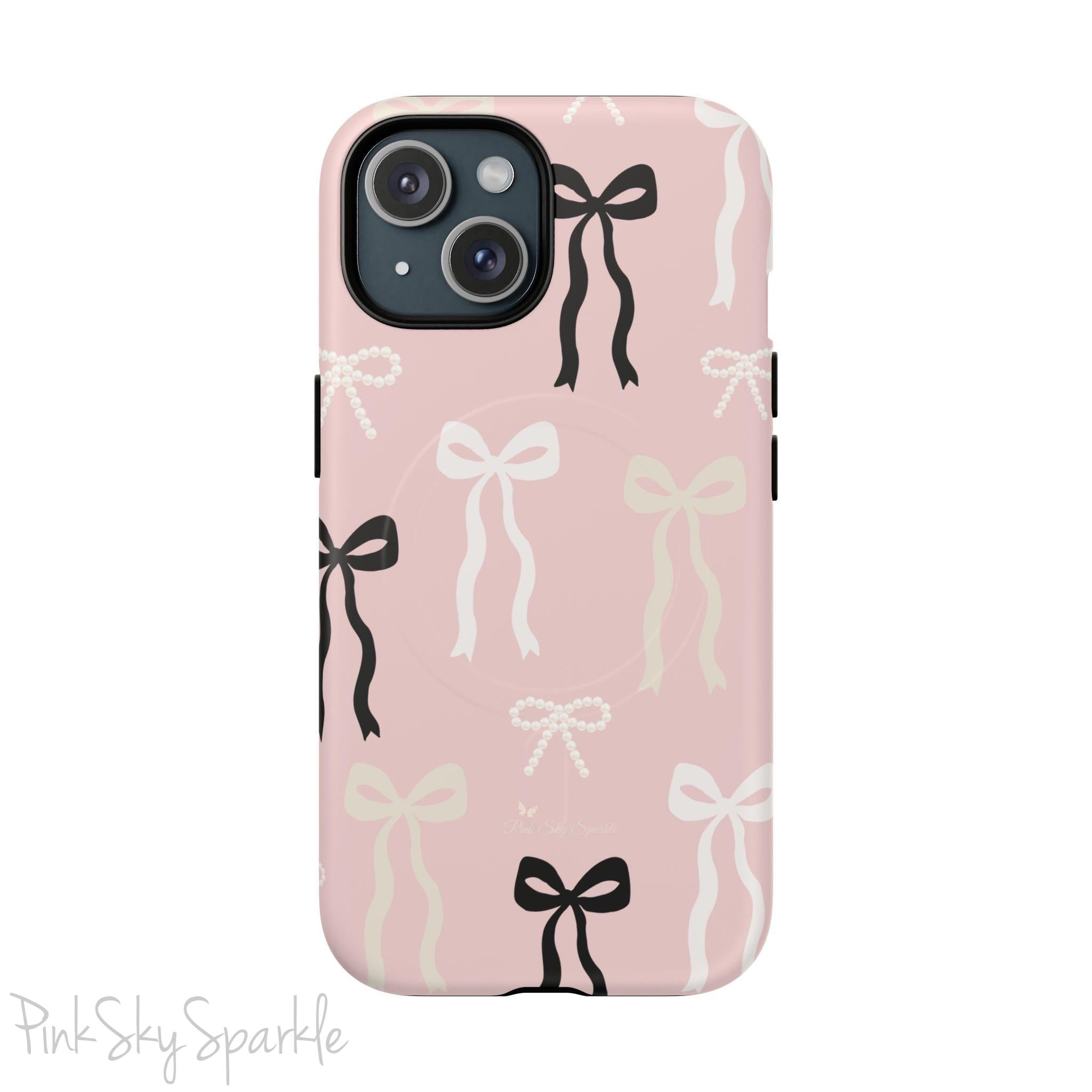 Pink magnetic iPhone case featuring an elegant bow pattern with black, white, and cream bows, designed for MagSafe® compatibility and premium protection.