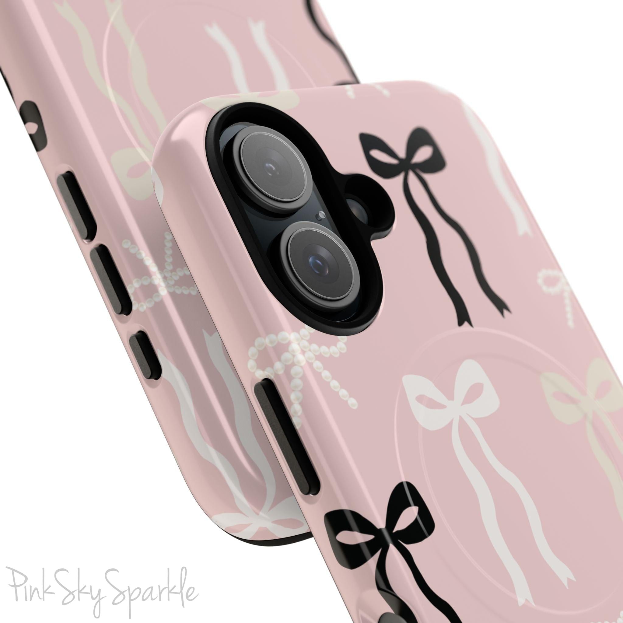 Pink magnetic iPhone case featuring an elegant bow pattern with black, white, and cream bows, designed for MagSafe® compatibility and premium protection.