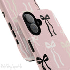 Pink magnetic iPhone case featuring an elegant bow pattern with black, white, and cream bows, designed for MagSafe® compatibility and premium protection.