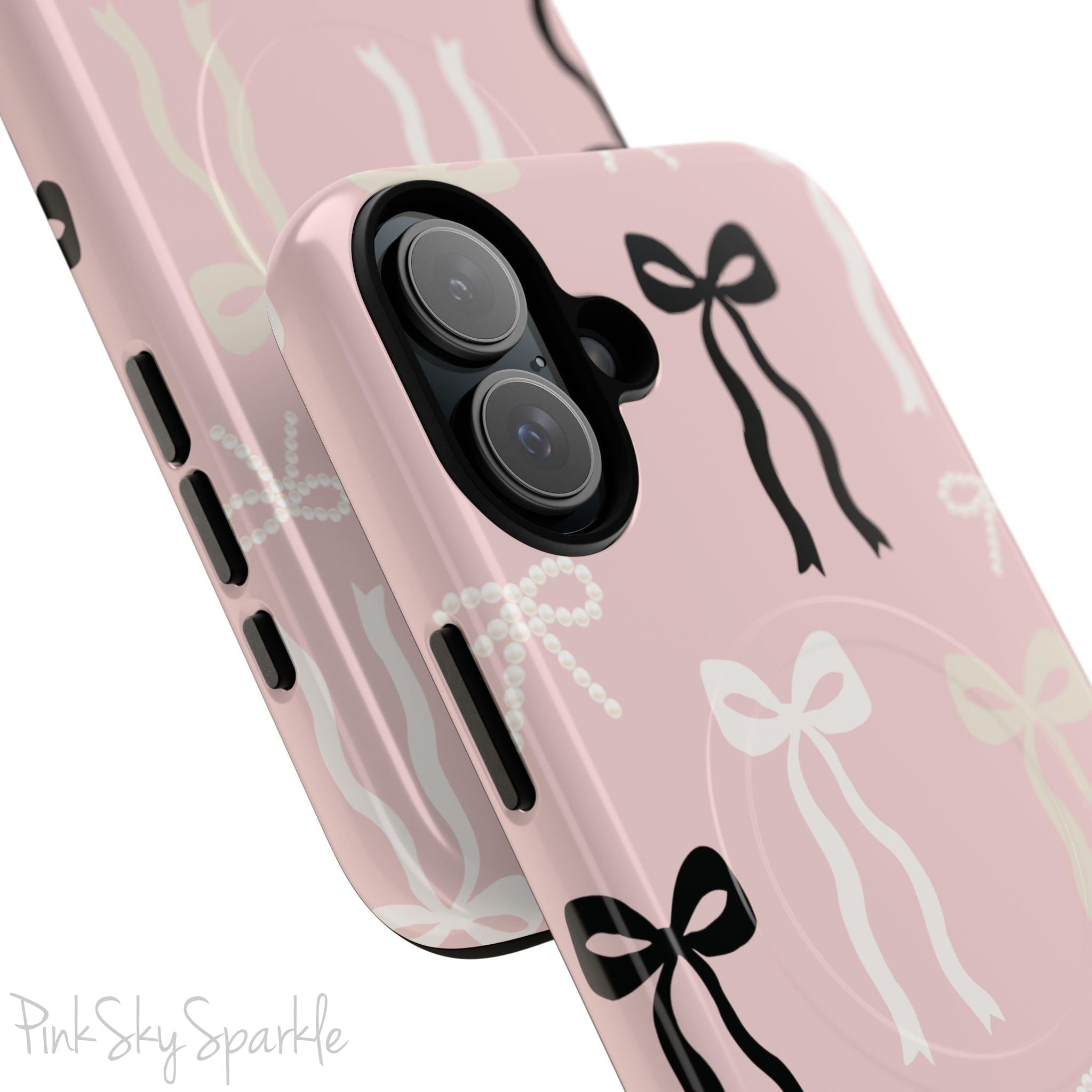 Pink magnetic iPhone case featuring an elegant bow pattern with black, white, and cream bows, designed for MagSafe® compatibility and premium protection.