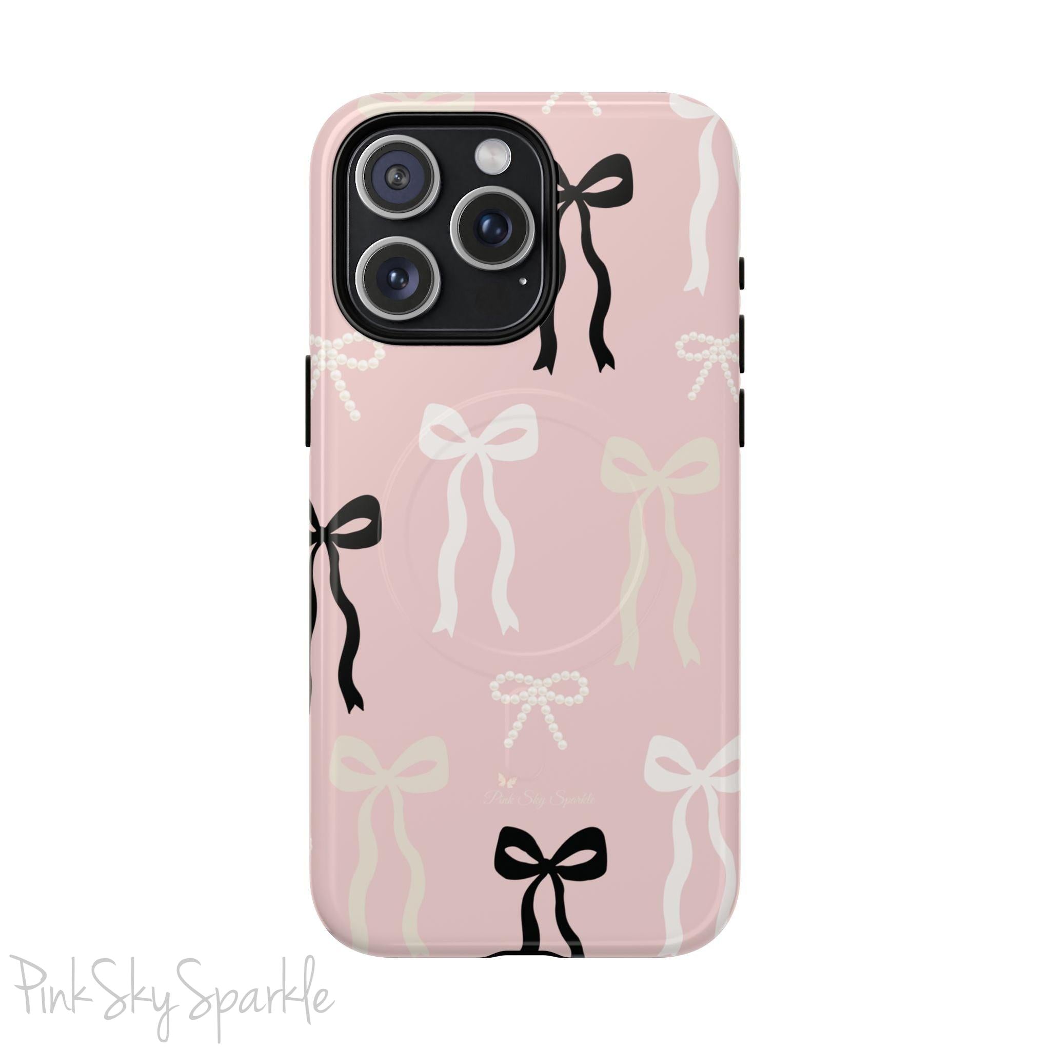 Pink magnetic iPhone case featuring an elegant bow pattern with black, white, and cream bows, designed for MagSafe® compatibility and premium protection.