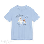 "All I need is coffee and my chihuahua" T-shirt. Featuring a graphic of a woman wearing a robe and hair towel, wearing black sunglasses drinking a coffee next to a chihuahua wearing black sunglasses.