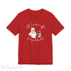 "All I need is coffee and my chihuahua" T-shirt. Featuring a graphic of a woman wearing a robe and hair towel, wearing black sunglasses drinking a coffee next to a chihuahua wearing black sunglasses.