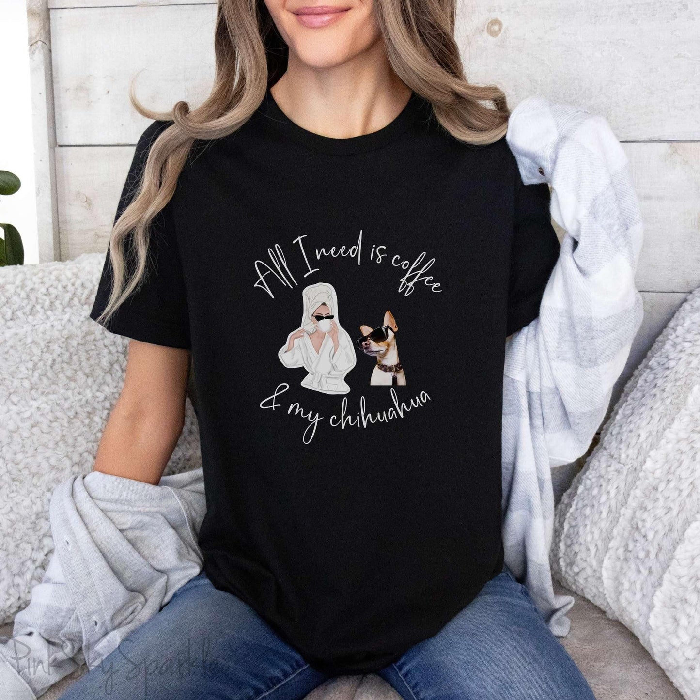 "All I need is coffee and my chihuahua" T-shirt. Featuring a graphic of a woman wearing a robe and hair towel, wearing black sunglasses drinking a coffee next to a chihuahua wearing black sunglasses.