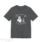 "All I need is coffee and my chihuahua" T-shirt. Featuring a graphic of a woman wearing a robe and hair towel, wearing black sunglasses drinking a coffee next to a chihuahua wearing black sunglasses.