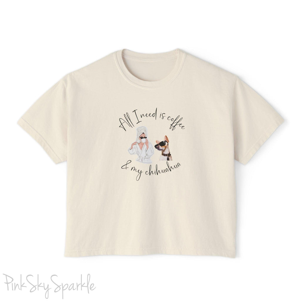 "All I need is coffee and my chihuahua" Women's Boxy Tee. Featuring a graphic of a woman wearing a robe and hair towel, wearing black sunglasses drinking a coffee next to a chihuahua wearing black sunglasses.
