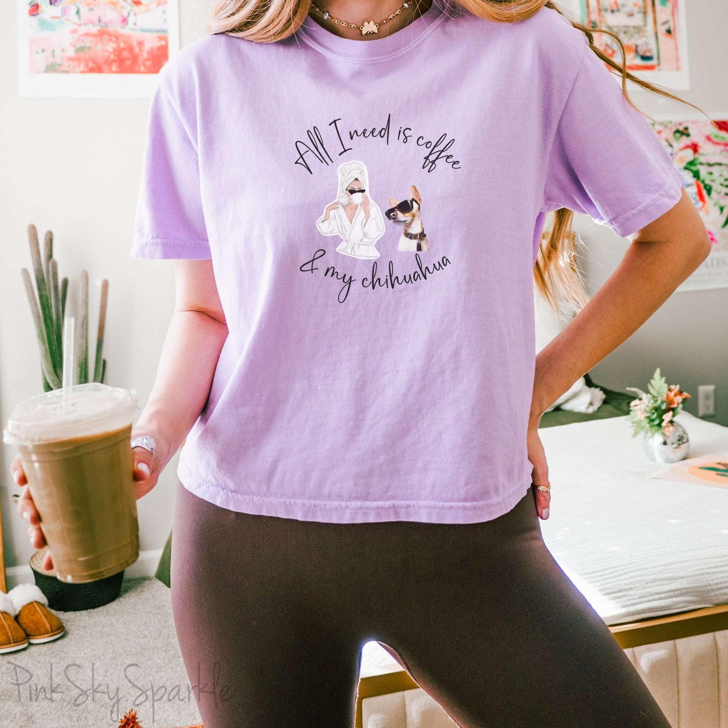 "All I need is coffee and my chihuahua" Women's Boxy Tee. Featuring a graphic of a woman wearing a robe and hair towel, wearing black sunglasses drinking a coffee next to a chihuahua wearing black sunglasses.