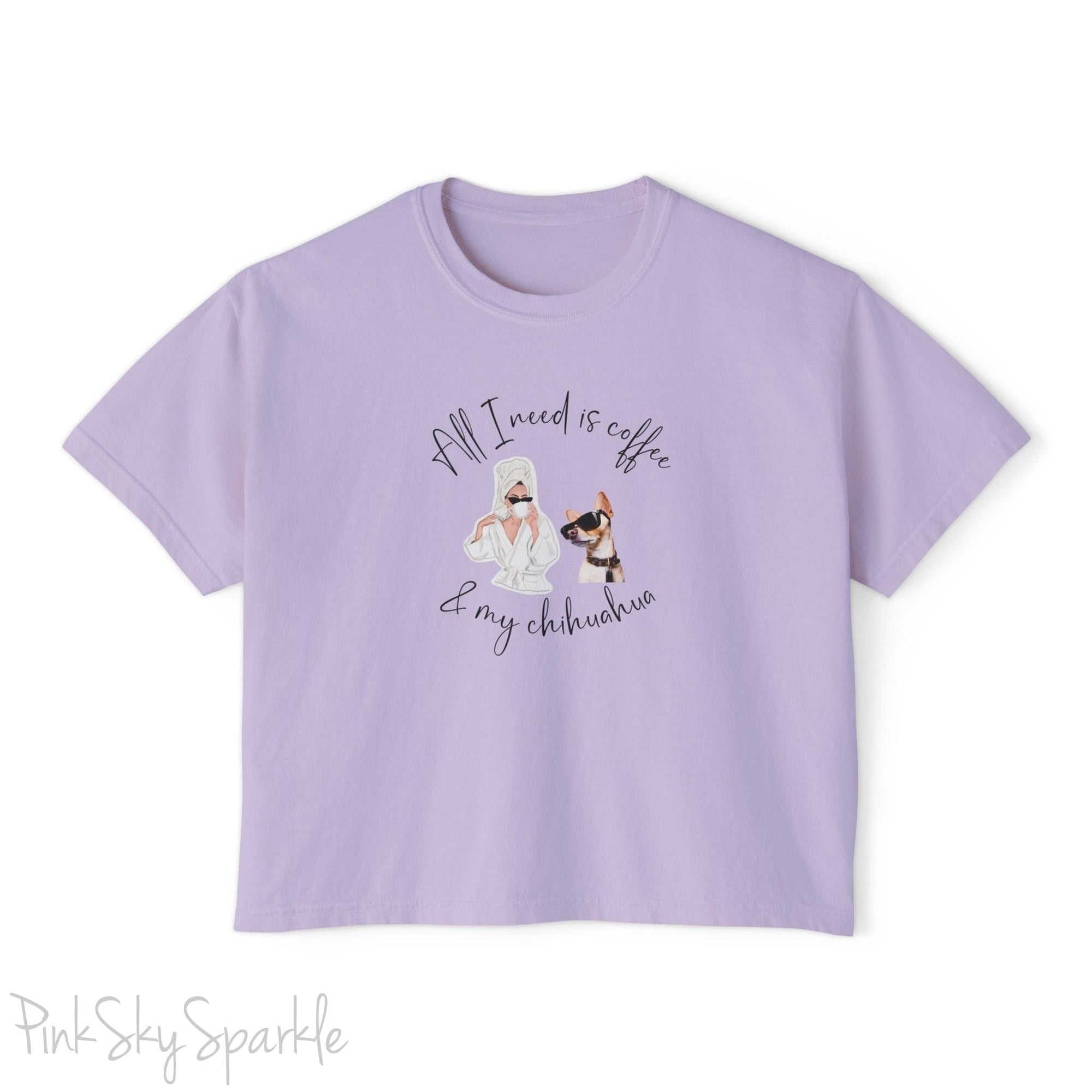 "All I need is coffee and my chihuahua" Women's Boxy Tee. Featuring a graphic of a woman wearing a robe and hair towel, wearing black sunglasses drinking a coffee next to a chihuahua wearing black sunglasses.