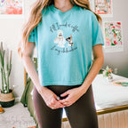 "All I need is coffee and my chihuahua" Women's Boxy Tee. Featuring a graphic of a woman wearing a robe and hair towel, wearing black sunglasses drinking a coffee next to a chihuahua wearing black sunglasses.