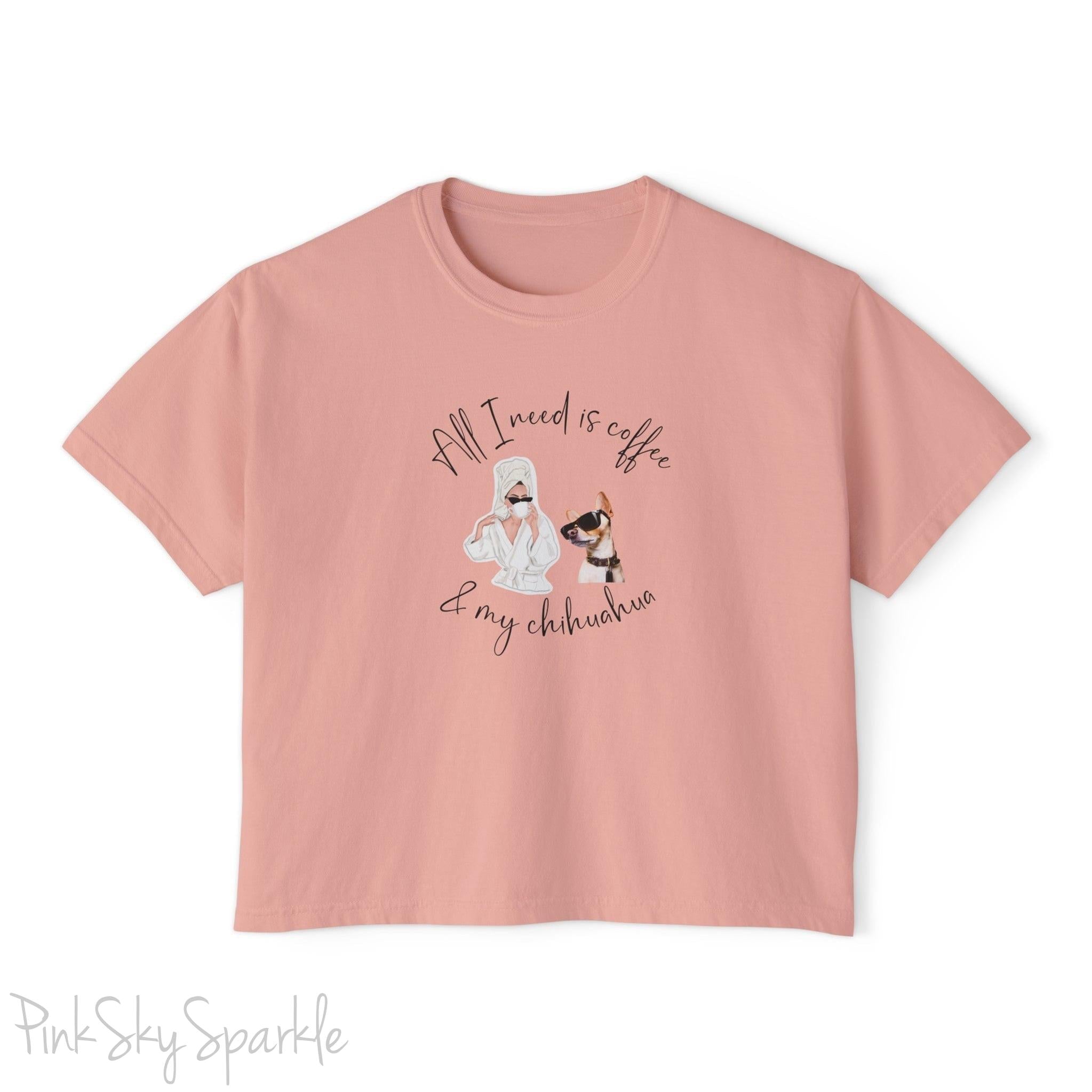 "All I need is coffee and my chihuahua" Women's Boxy Tee. Featuring a graphic of a woman wearing a robe and hair towel, wearing black sunglasses drinking a coffee next to a chihuahua wearing black sunglasses.
