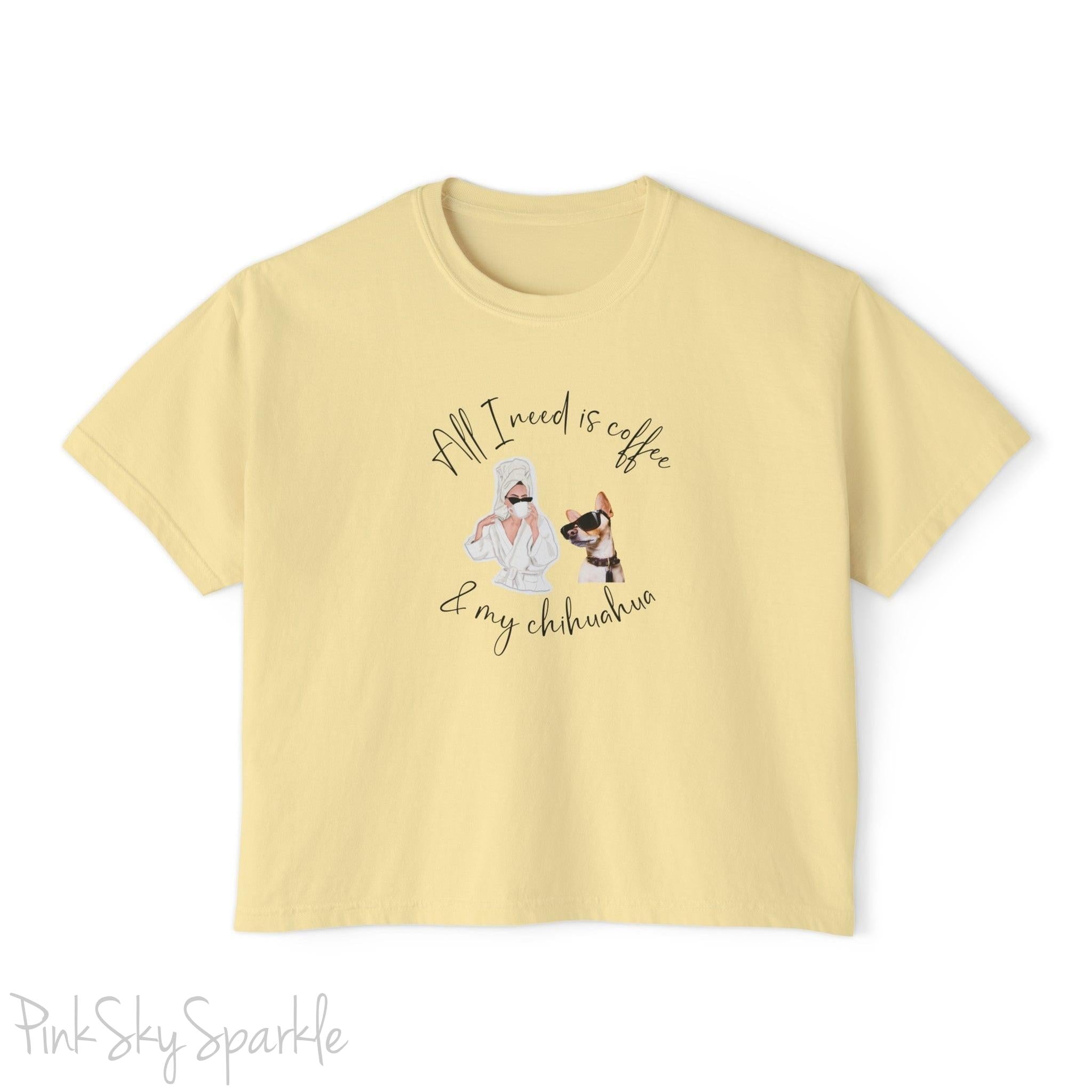 "All I need is coffee and my chihuahua" Women's Boxy Tee. Featuring a graphic of a woman wearing a robe and hair towel, wearing black sunglasses drinking a coffee next to a chihuahua wearing black sunglasses.