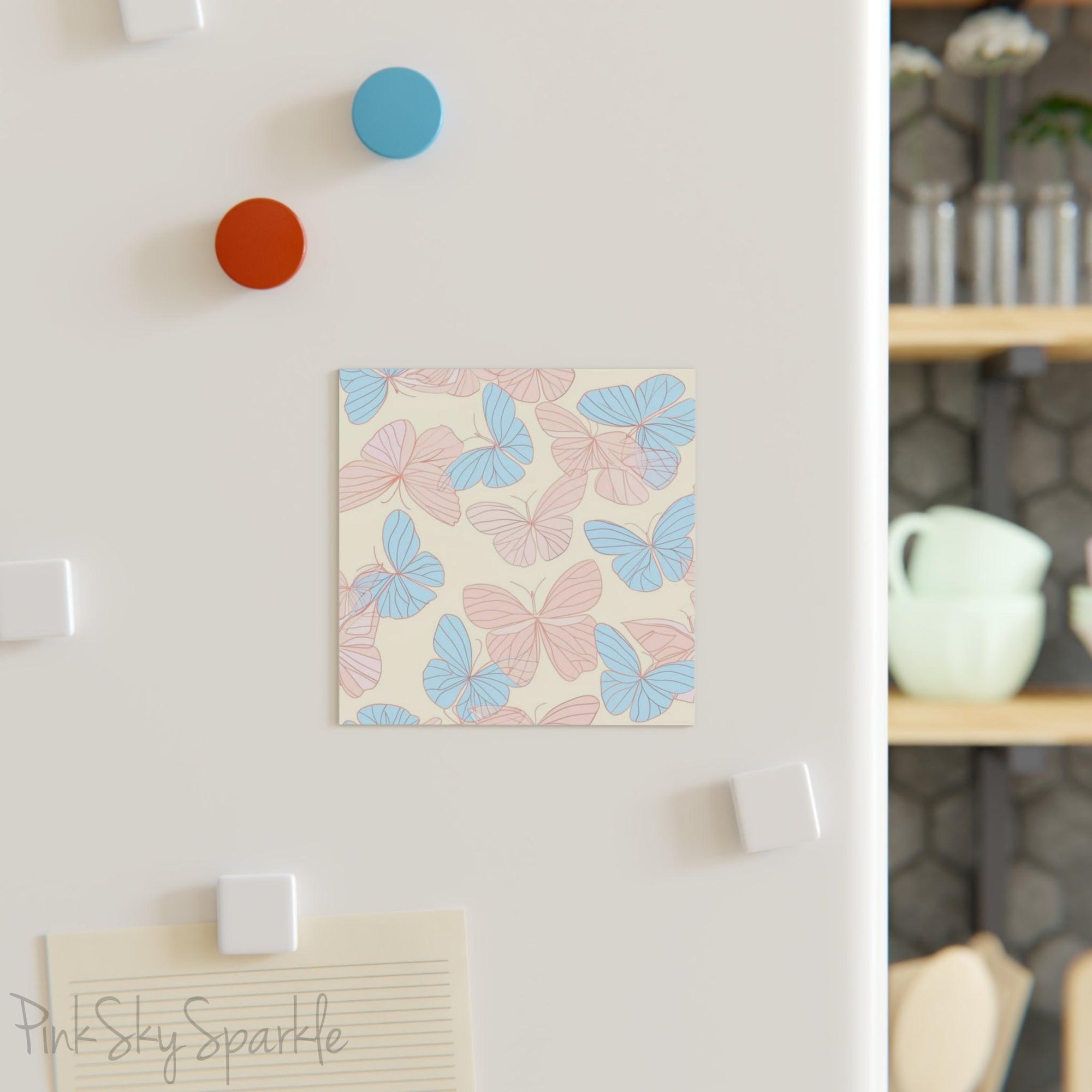 Beautiful Pink and Blue Butterfly Square Magnet with a neutral ivory coloured background. Can be used on the refrigerator or any magnetic surface.