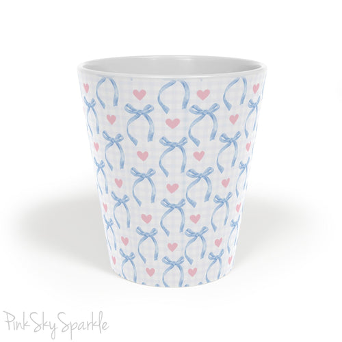 Blue Coquette 12oz Latte Mug,  featuring a light blue gingham print with delicate blue bows and pink hearts, this cute and stylish mug is perfect for your favourite coffee, tea, or hot cocoa. 