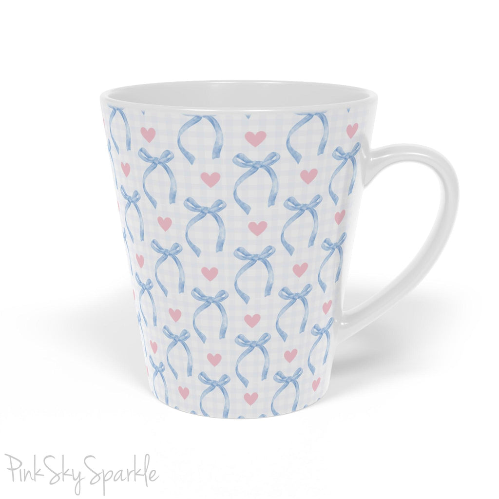 Blue Coquette 12oz Latte Mug,  featuring a light blue gingham print with delicate blue bows and pink hearts, this cute and stylish mug is perfect for your favourite coffee, tea, or hot cocoa. 