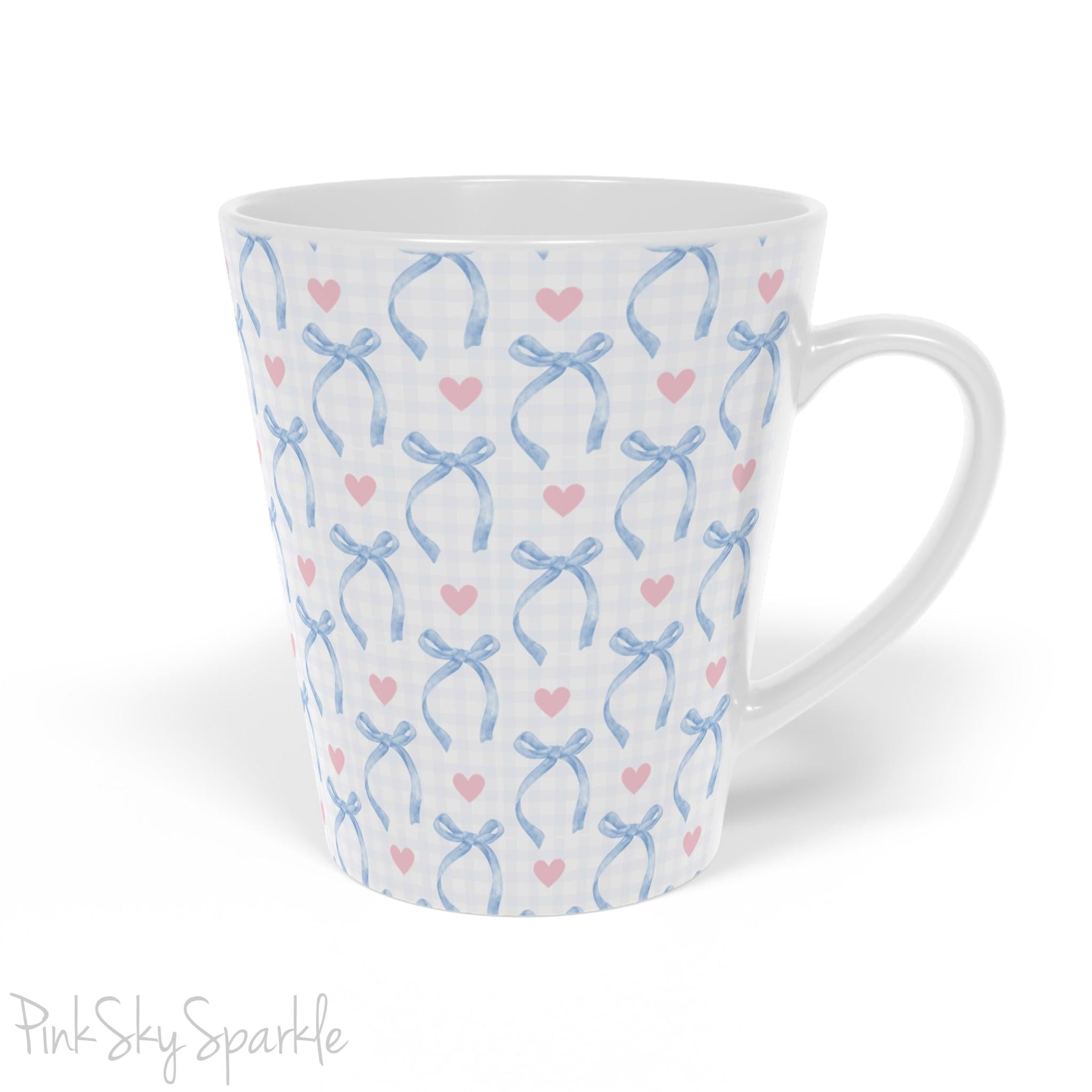 Blue Coquette 12oz Latte Mug,  featuring a light blue gingham print with delicate blue bows and pink hearts, this cute and stylish mug is perfect for your favourite coffee, tea, or hot cocoa. 