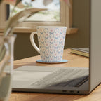 Blue Coquette 12oz Latte Mug,  featuring a light blue gingham print with delicate blue bows and pink hearts, this cute and stylish mug is perfect for your favourite coffee, tea, or hot cocoa. 
