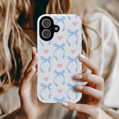 Blue Coquette Magnetic iPhone Case featuring a light blue gingham pattern with bows and hearts, compatible with iPhone 13, 14, 15, and 16 models.