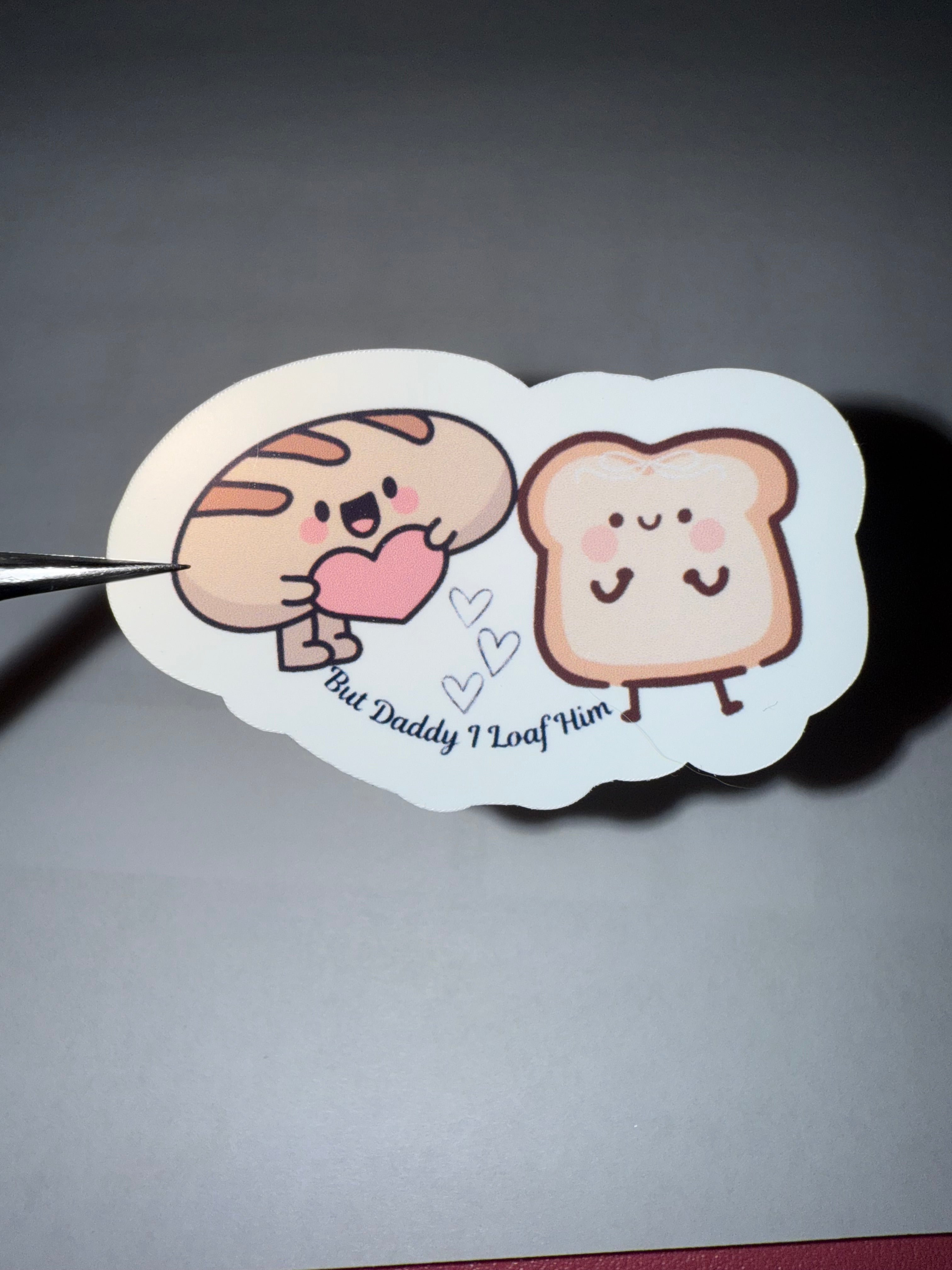 Cute sticker with bread cartoons characters and the pun "but daddy I loaf him"