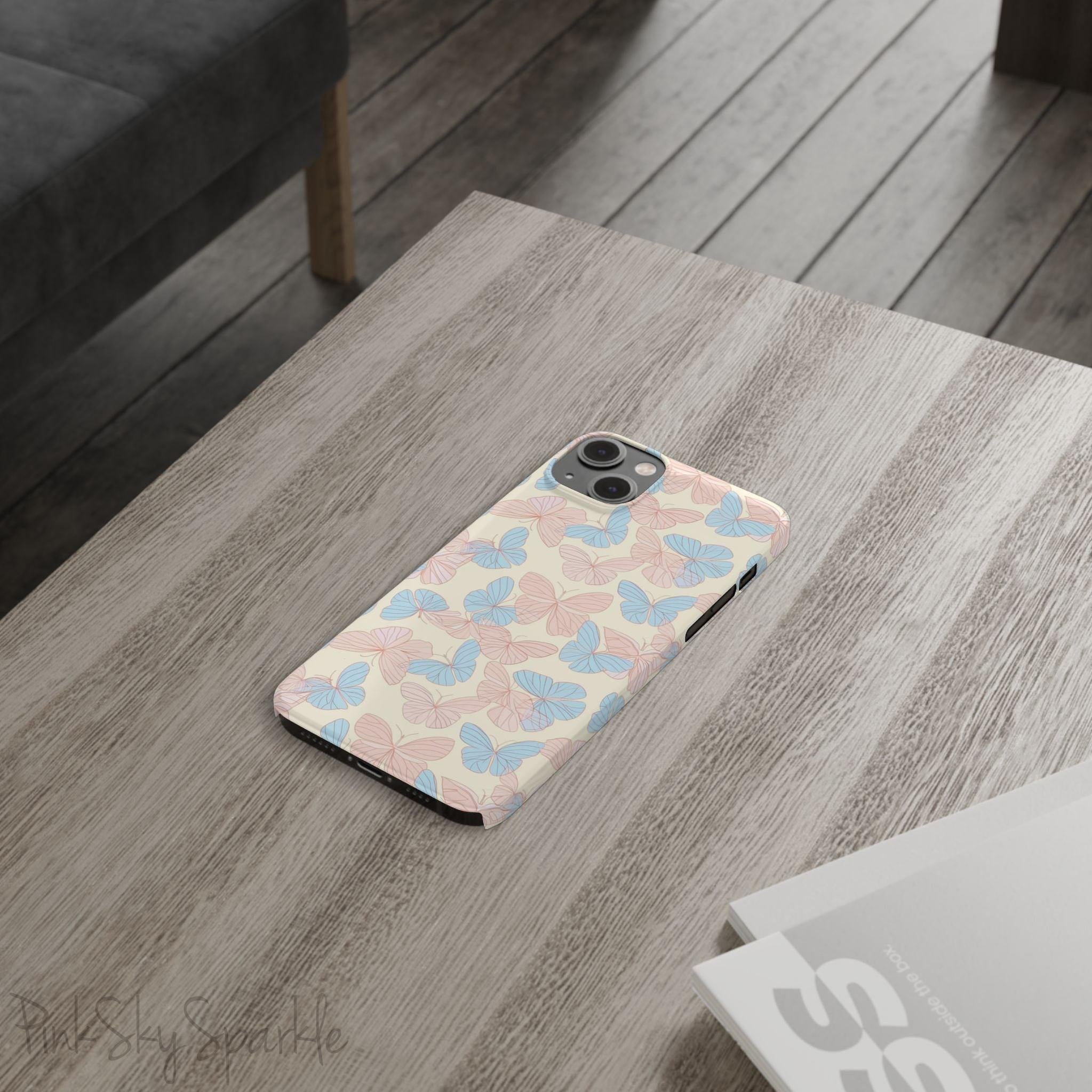 Butterfly Slim iPhone Case. Featuring a neutral background with a pattern of light pink and light blue butterflies.