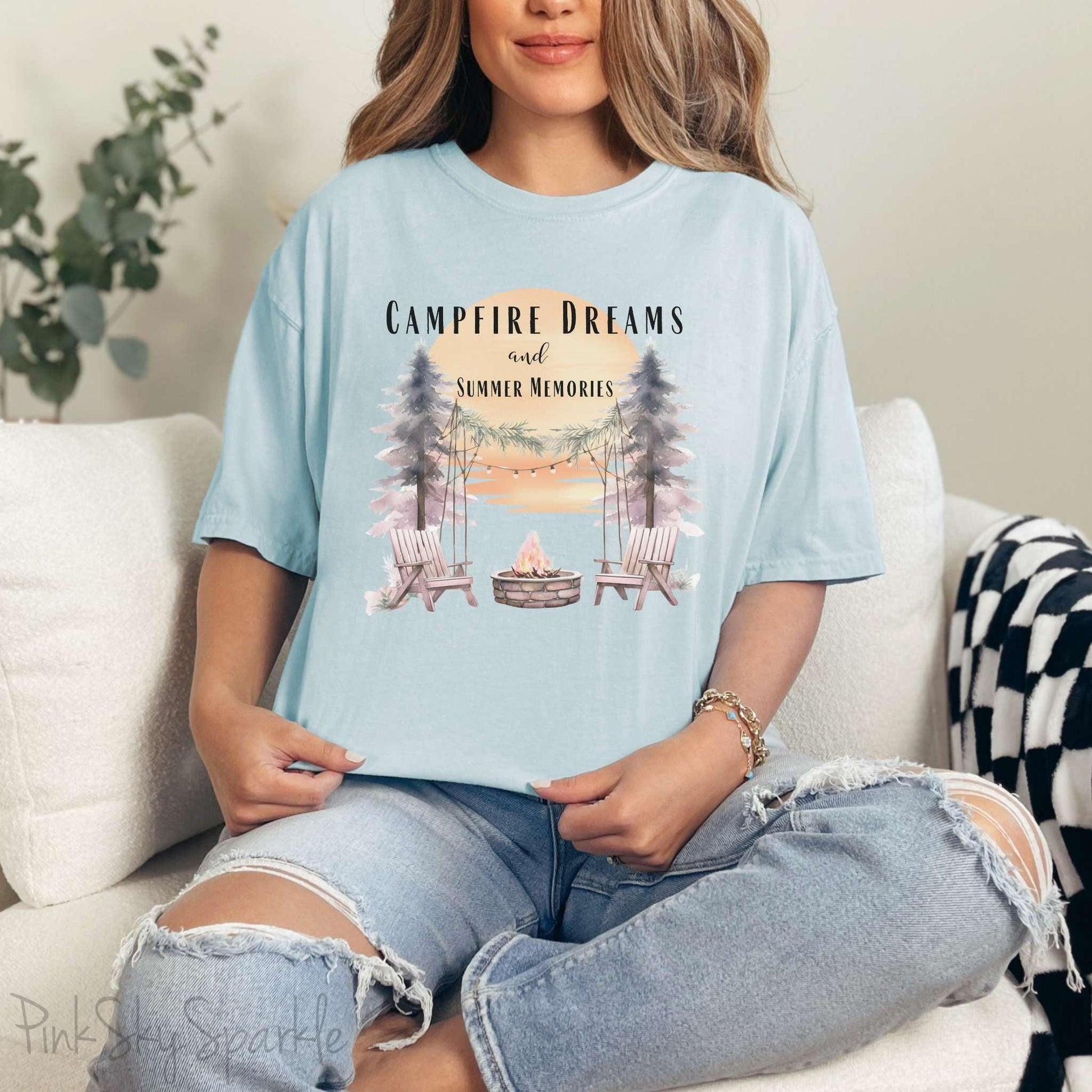 Campfire Dreams and Summer Memories Unisex Garment-Dyed T-shirt. Escape to the great outdoors with our Campfire Dreams and Summer Memories Garment-Dyed T-shirt. Made from soft, high-quality fabric, this shirt is perfect for cozy nights by the fire or creating unforgettable summer memories. Featuring the graphics of a scenery of a sunset, trees, patio lights, a fire pit and two wood chairs.