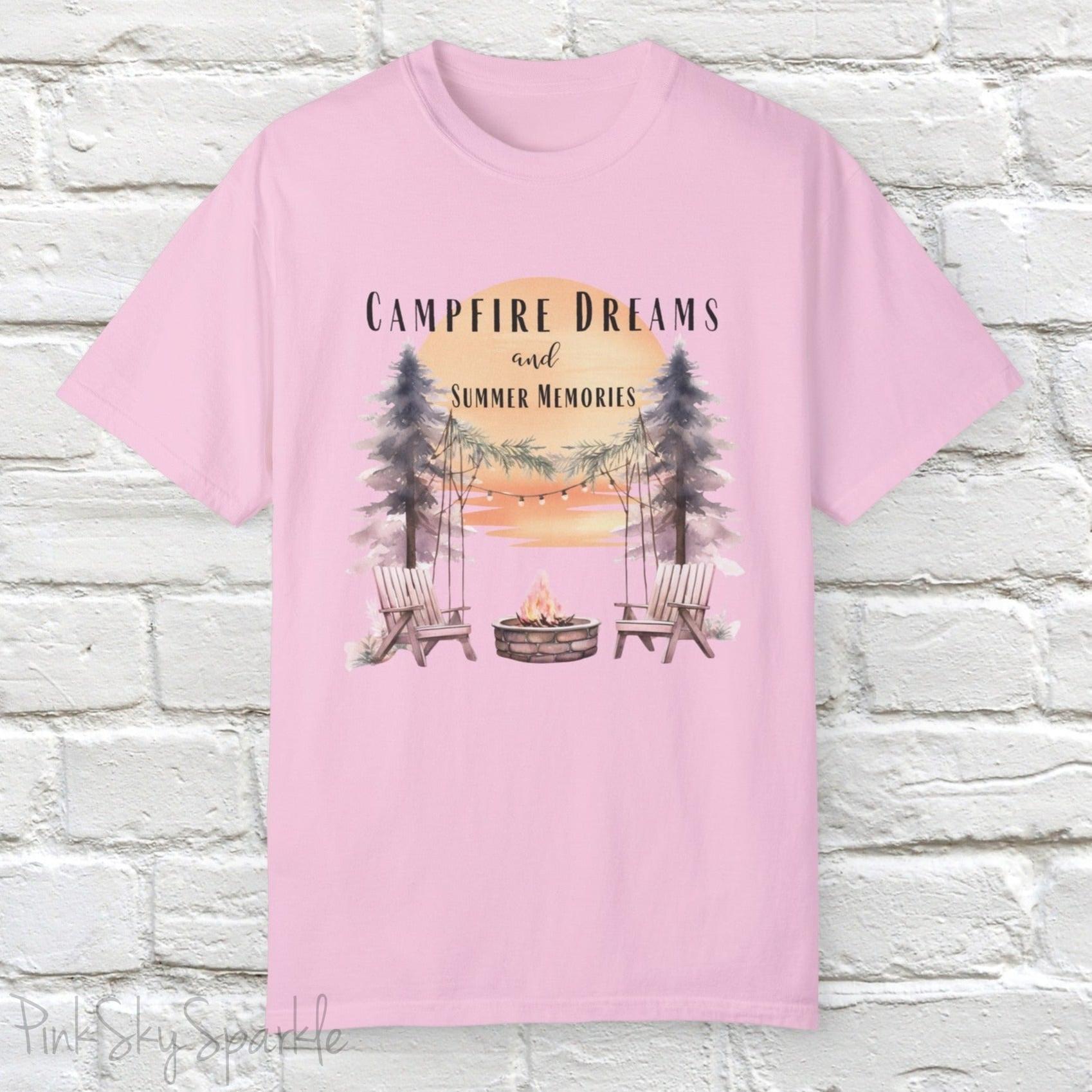 Campfire Dreams and Summer Memories Unisex Garment-Dyed T-shirt. Escape to the great outdoors with our Campfire Dreams and Summer Memories Garment-Dyed T-shirt. Made from soft, high-quality fabric, this shirt is perfect for cozy nights by the fire or creating unforgettable summer memories. Featuring the graphics of a scenery of a sunset, trees, patio lights, a fire pit and two wood chairs.