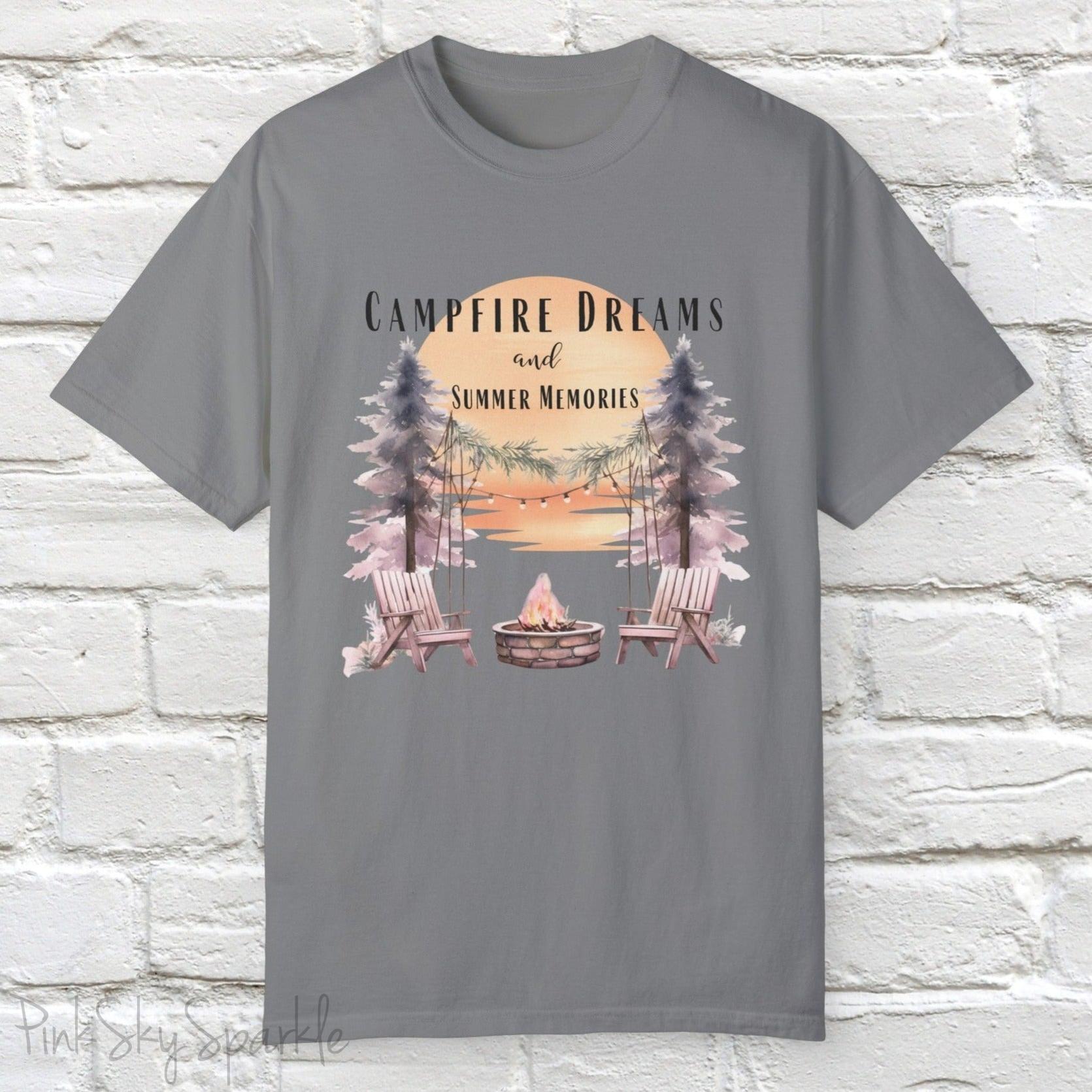 Campfire Dreams and Summer Memories Unisex Garment-Dyed T-shirt. Escape to the great outdoors with our Campfire Dreams and Summer Memories Garment-Dyed T-shirt. Made from soft, high-quality fabric, this shirt is perfect for cozy nights by the fire or creating unforgettable summer memories. Featuring the graphics of a scenery of a sunset, trees, patio lights, a fire pit and two wood chairs.