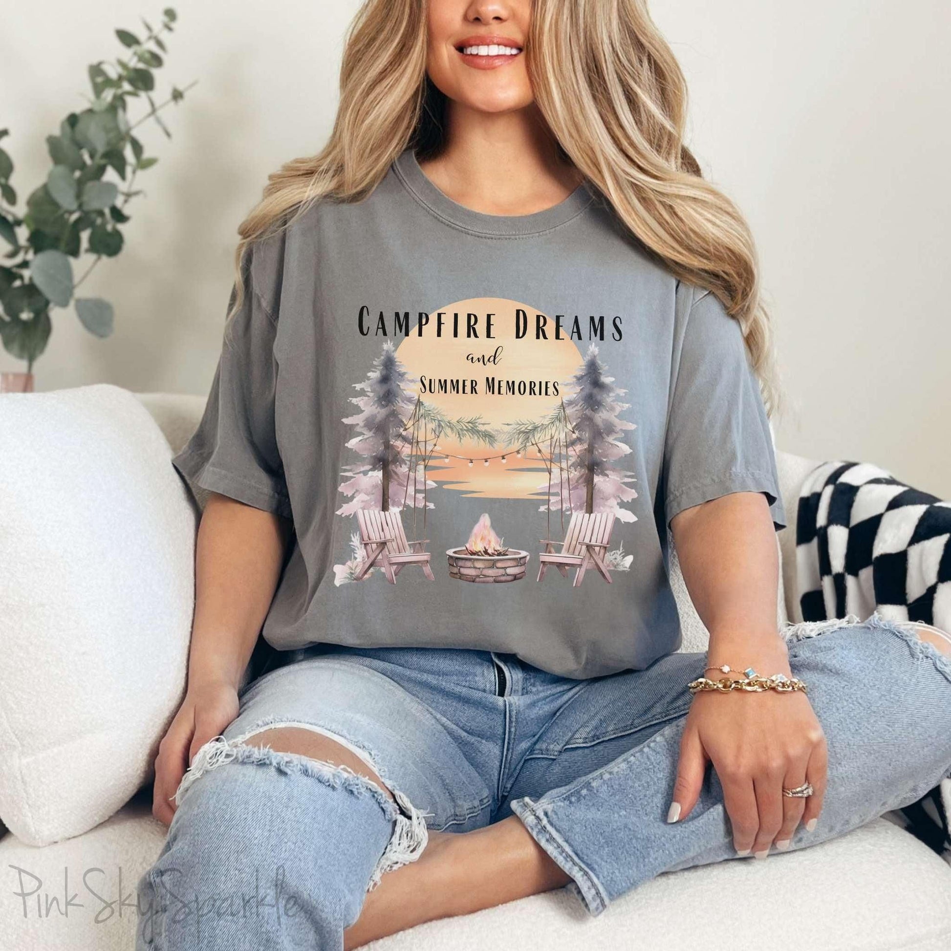 Campfire Dreams and Summer Memories Unisex Garment-Dyed T-shirt. Escape to the great outdoors with our Campfire Dreams and Summer Memories Garment-Dyed T-shirt. Made from soft, high-quality fabric, this shirt is perfect for cozy nights by the fire or creating unforgettable summer memories. Featuring the graphics of a scenery of a sunset, trees, patio lights, a fire pit and two wood chairs.