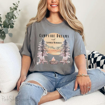 Campfire Dreams and Summer Memories Unisex Garment-Dyed T-shirt. Escape to the great outdoors with our Campfire Dreams and Summer Memories Garment-Dyed T-shirt. Made from soft, high-quality fabric, this shirt is perfect for cozy nights by the fire or creating unforgettable summer memories. Featuring the graphics of a scenery of a sunset, trees, patio lights, a fire pit and two wood chairs.